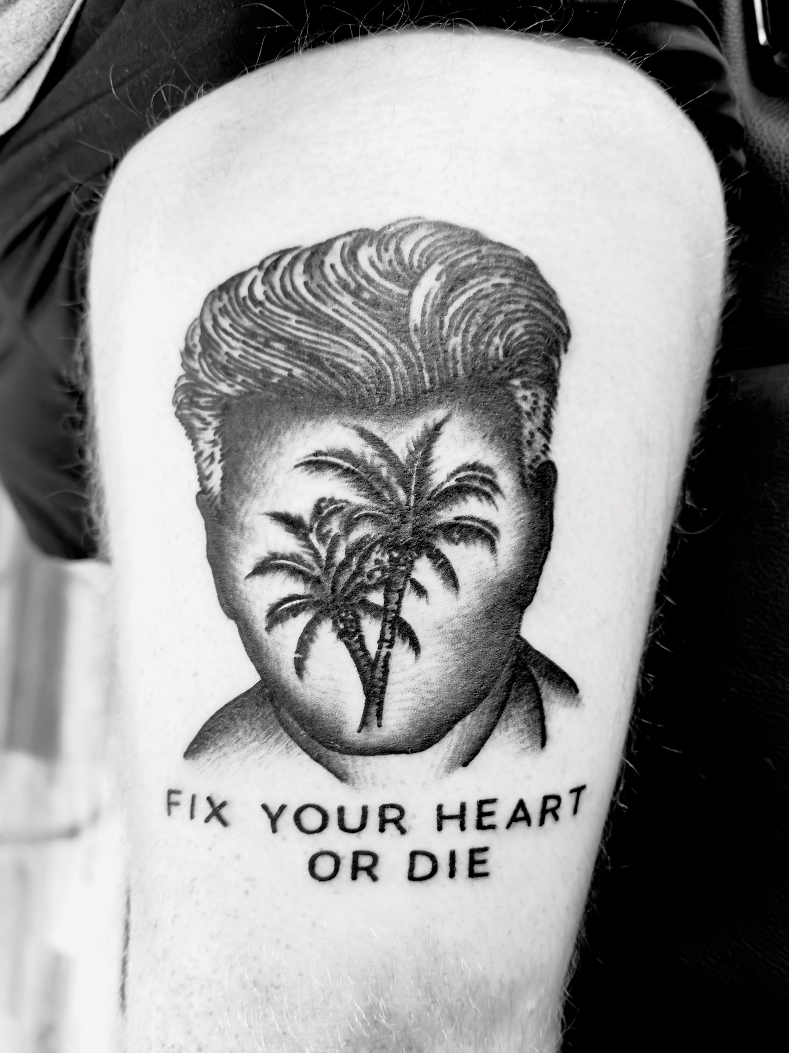 Hair and palms black and grey tattoo on the forearm by Jimmy Kelley