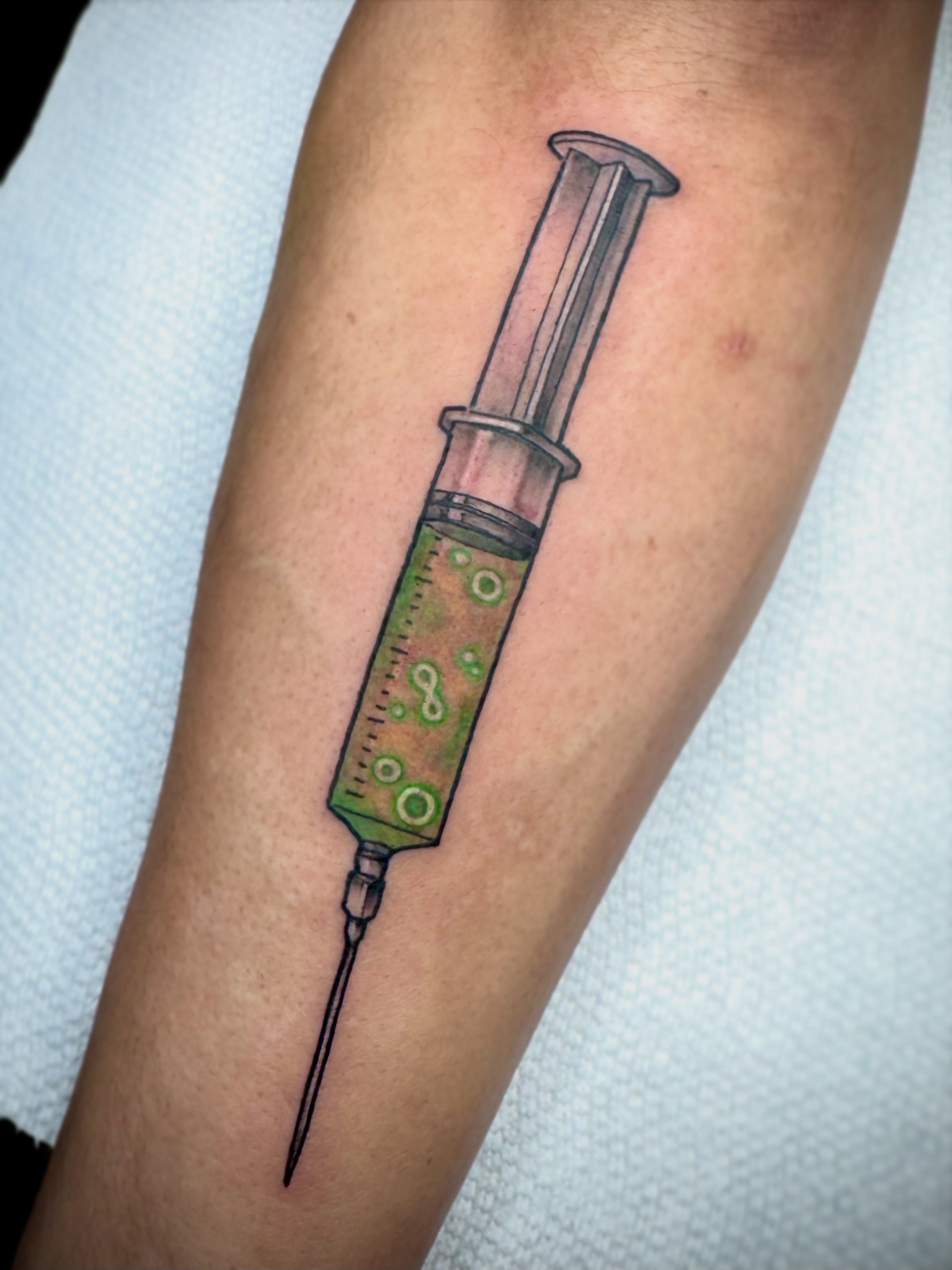 Syringe realism tattoo on the forearm by 🏵