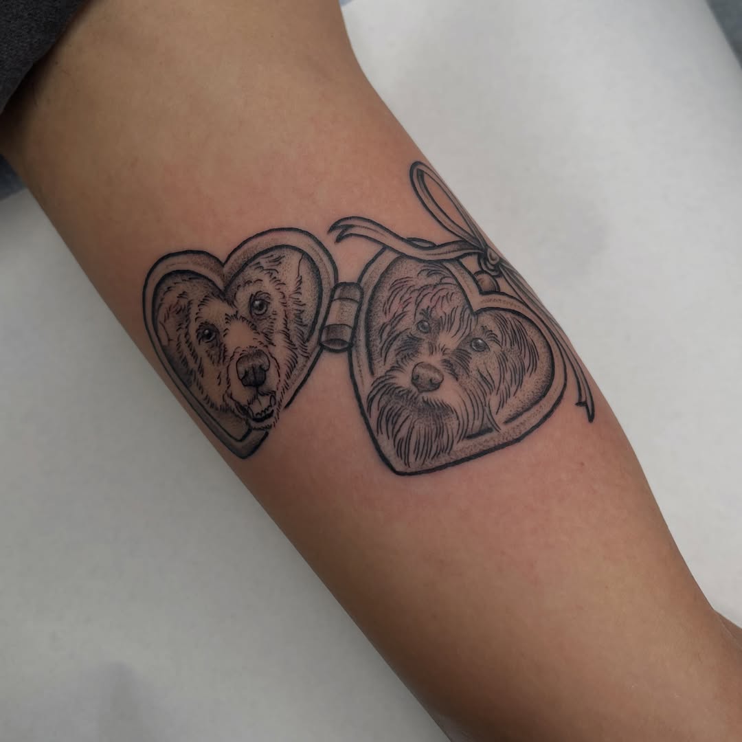 Heart-shaped dogs realism tattoo on the forearm by Allison Gallagher