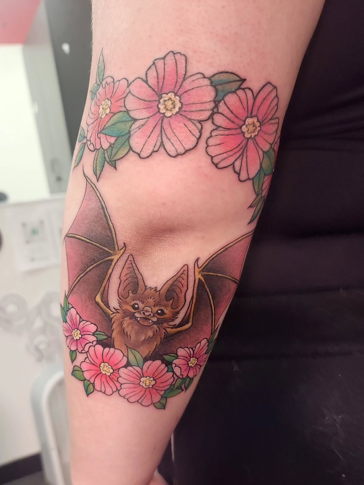 Bat and flowers new school tattoo on the forearm by Samantha Von Zombia, Saint Paul, Minnesota