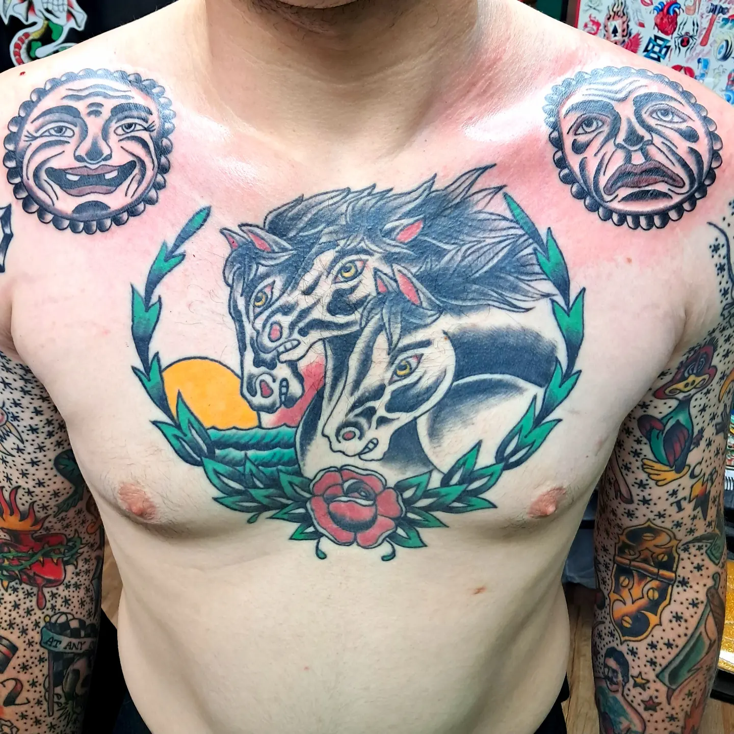Horses and laurel wreath American traditional tattoo on the chest by Reb Fularz