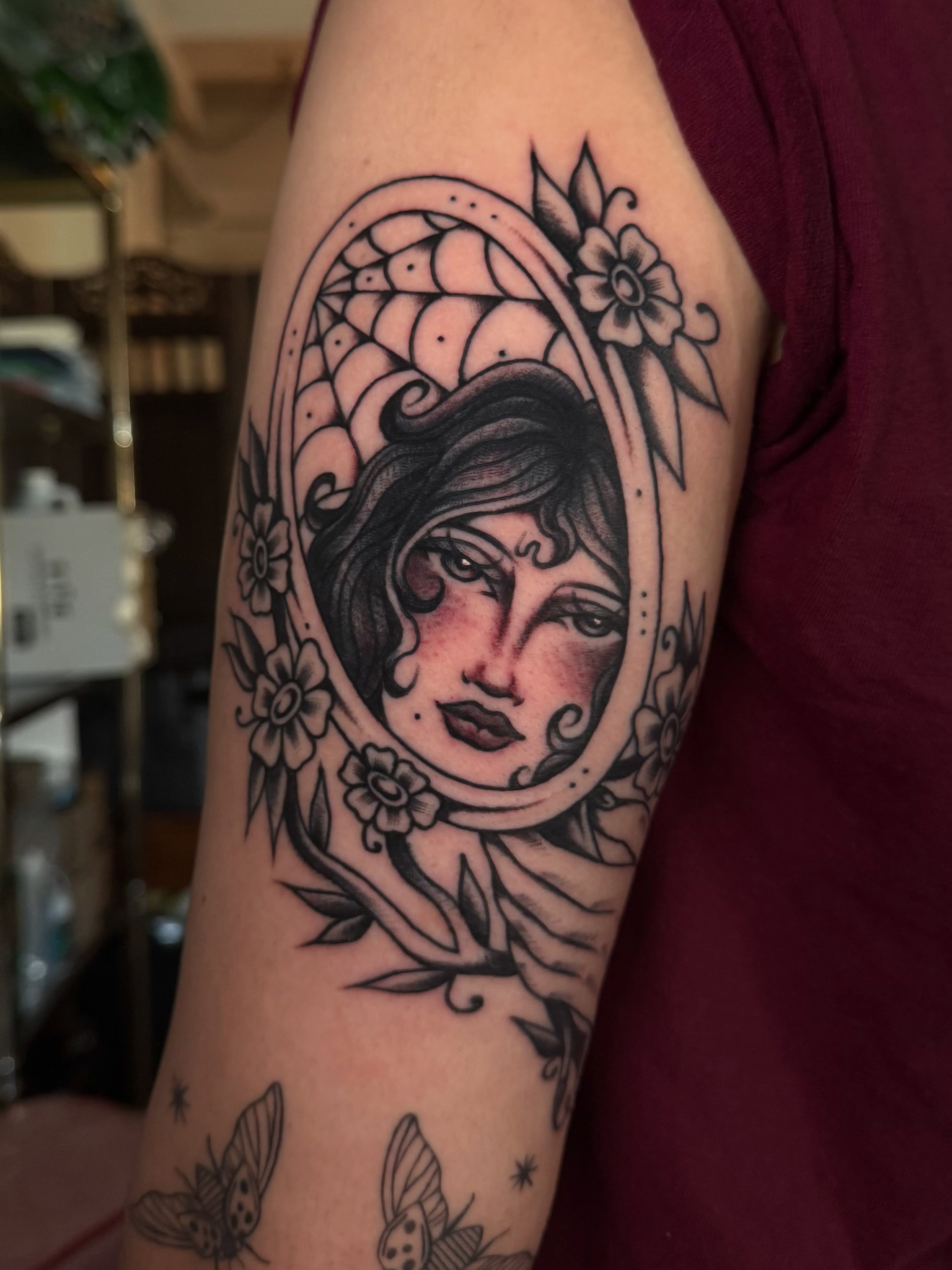 Woman's face American traditional tattoo on the forearm by Painted Peach Tattooer