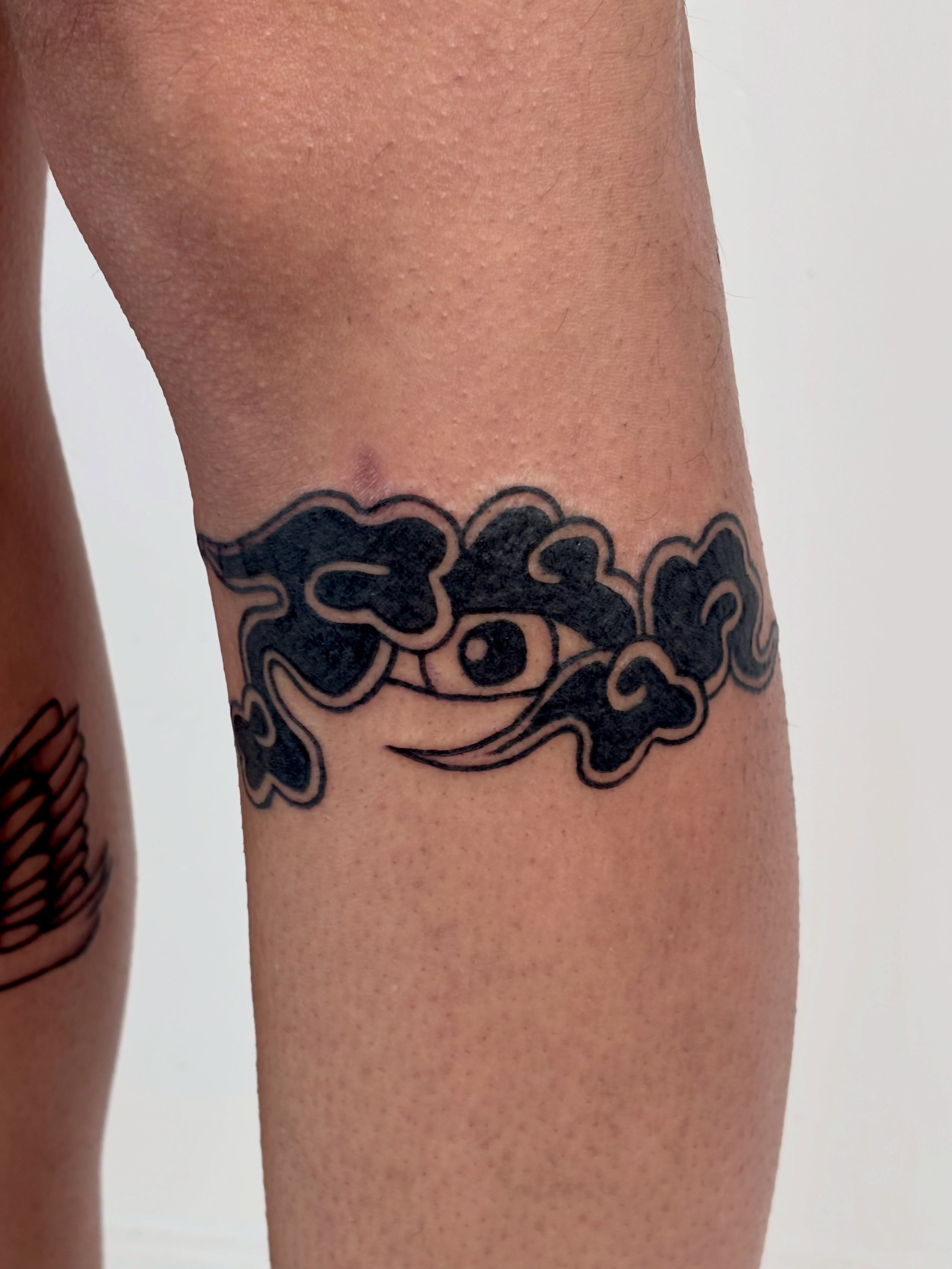 Smoke cloud black and grey tattoo on the forearm by Topher Belmont