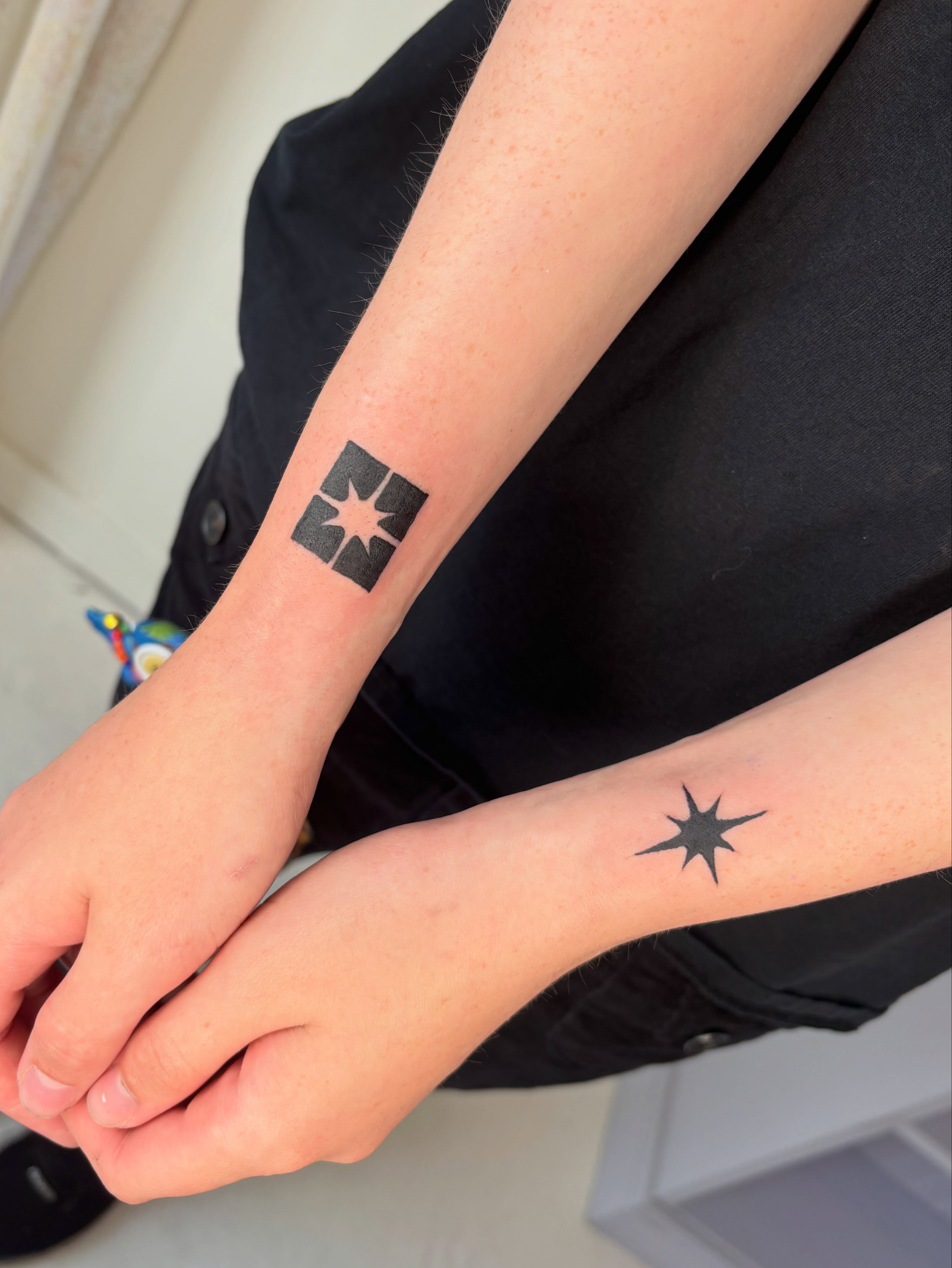Star geometric tattoo on the forearm by Topher Belmont