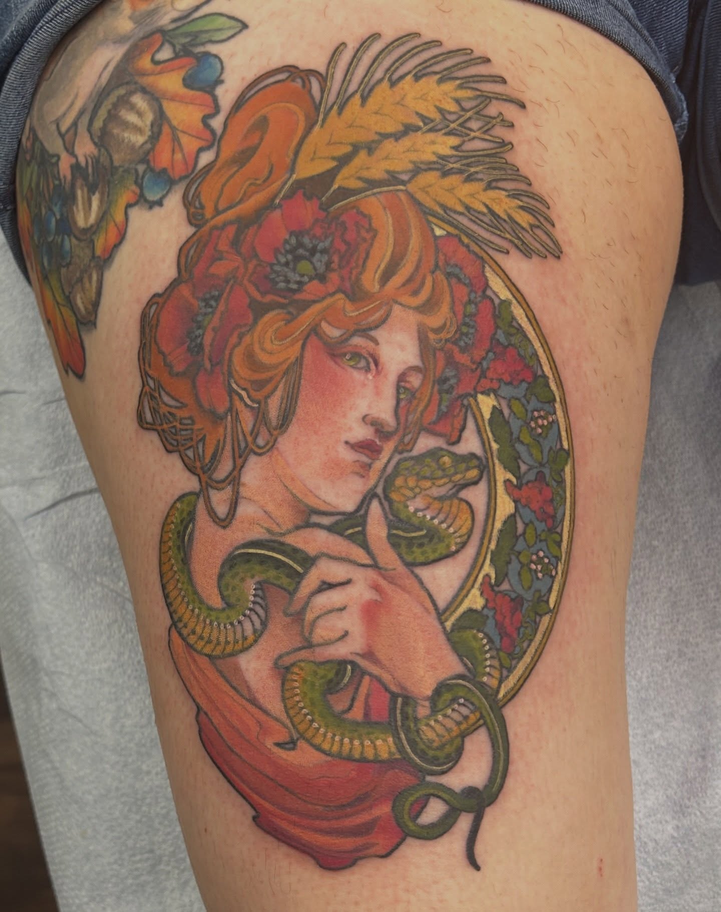 Woman with snake illustrative tattoo on the thigh by Anna Sylvan Tattoos