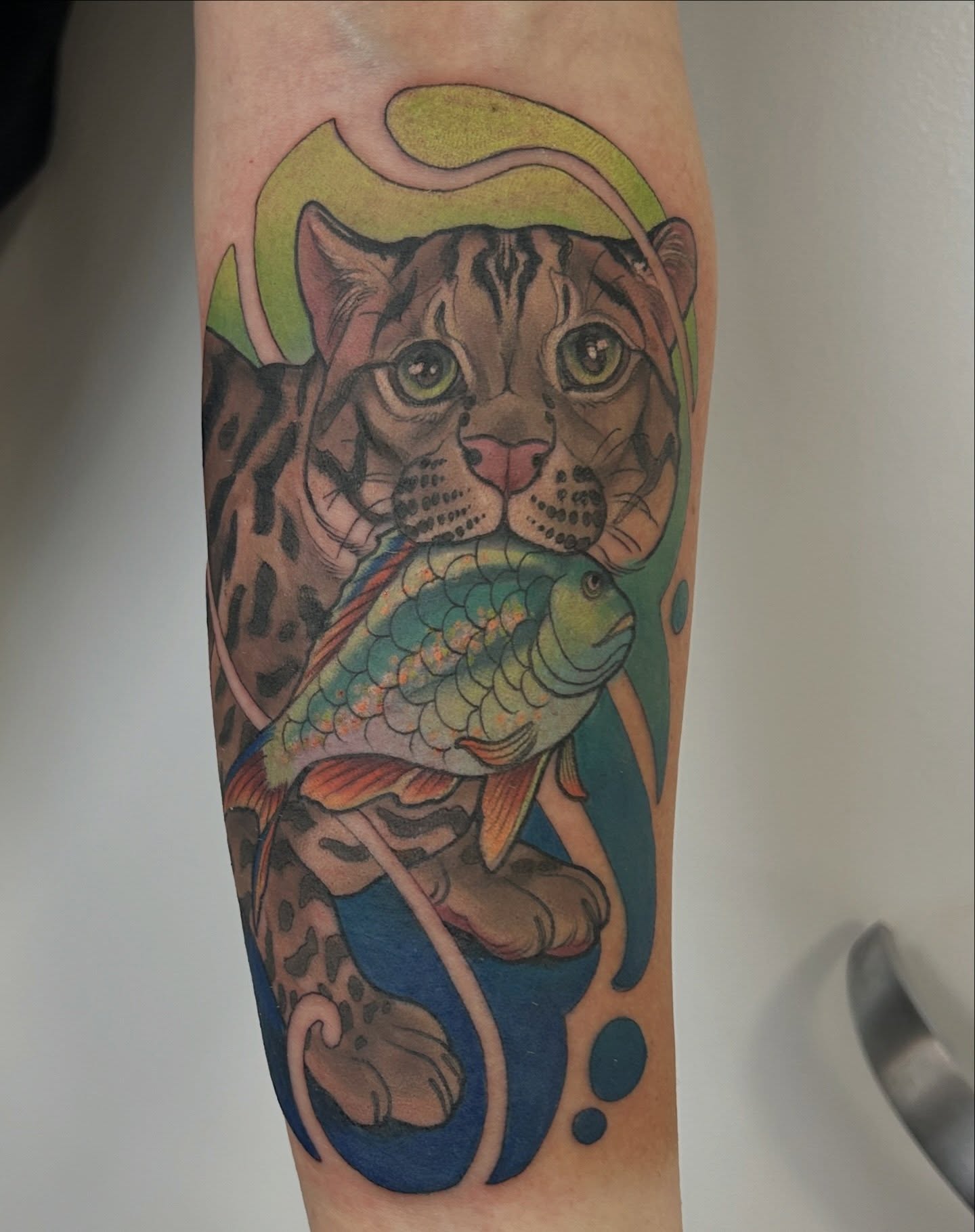 Jaguar and fish realism tattoo on the forearm by Anna Sylvan Tattoos