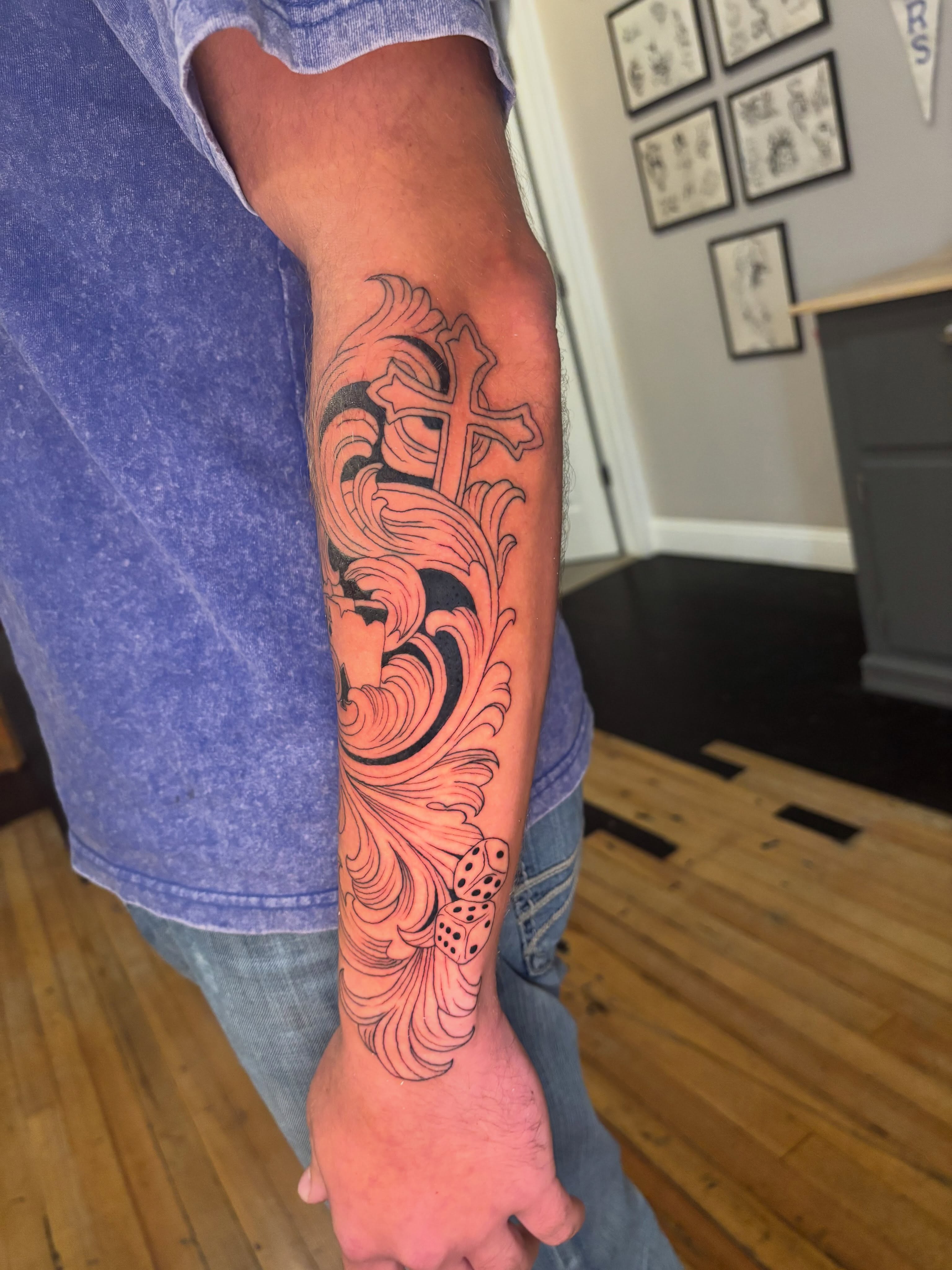 Cross and floral design neo-traditional tattoo on the forearm by Aubri Aunna