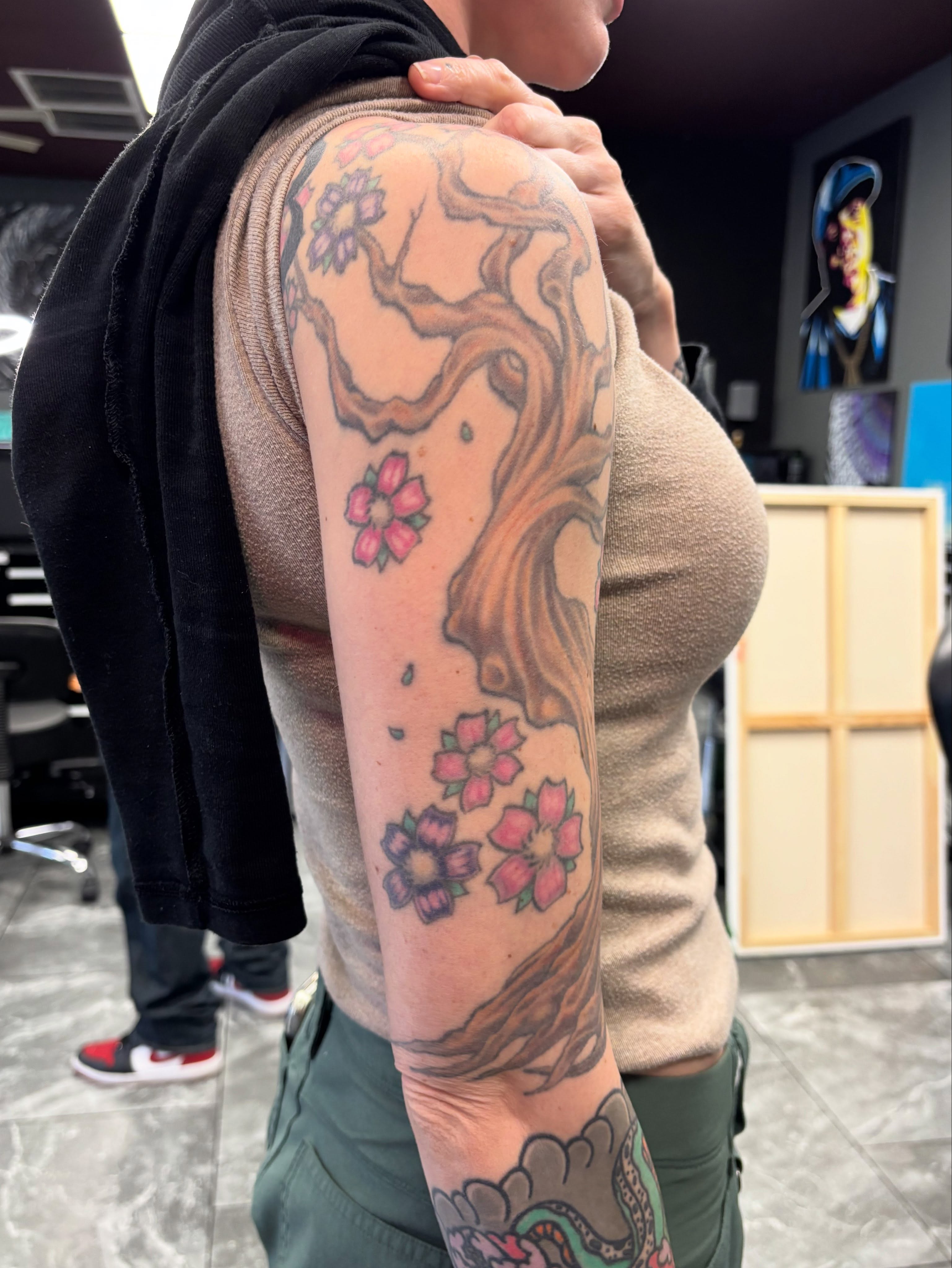 Cherry blossoms and tree japanese irezumi tattoo on the upper arm by Jennifer Flores