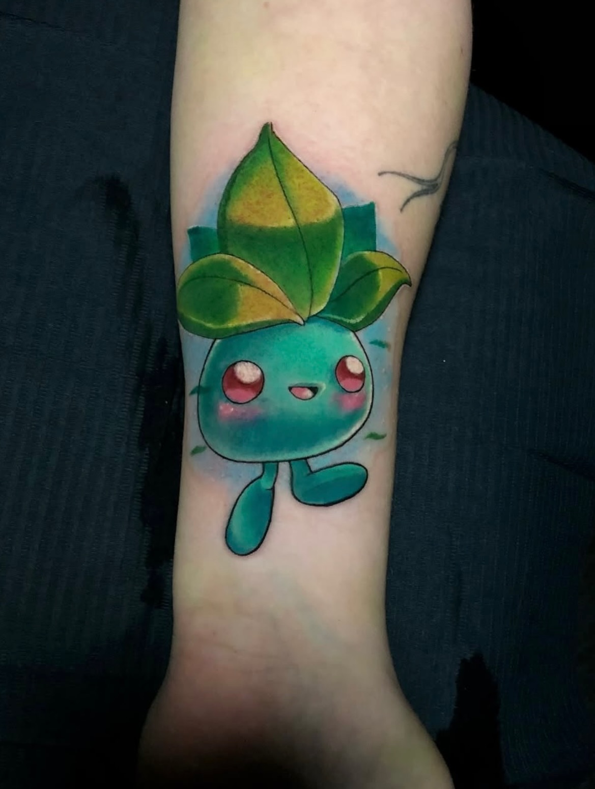 Leafy creature watercolor tattoo on the forearm by Frank Miller