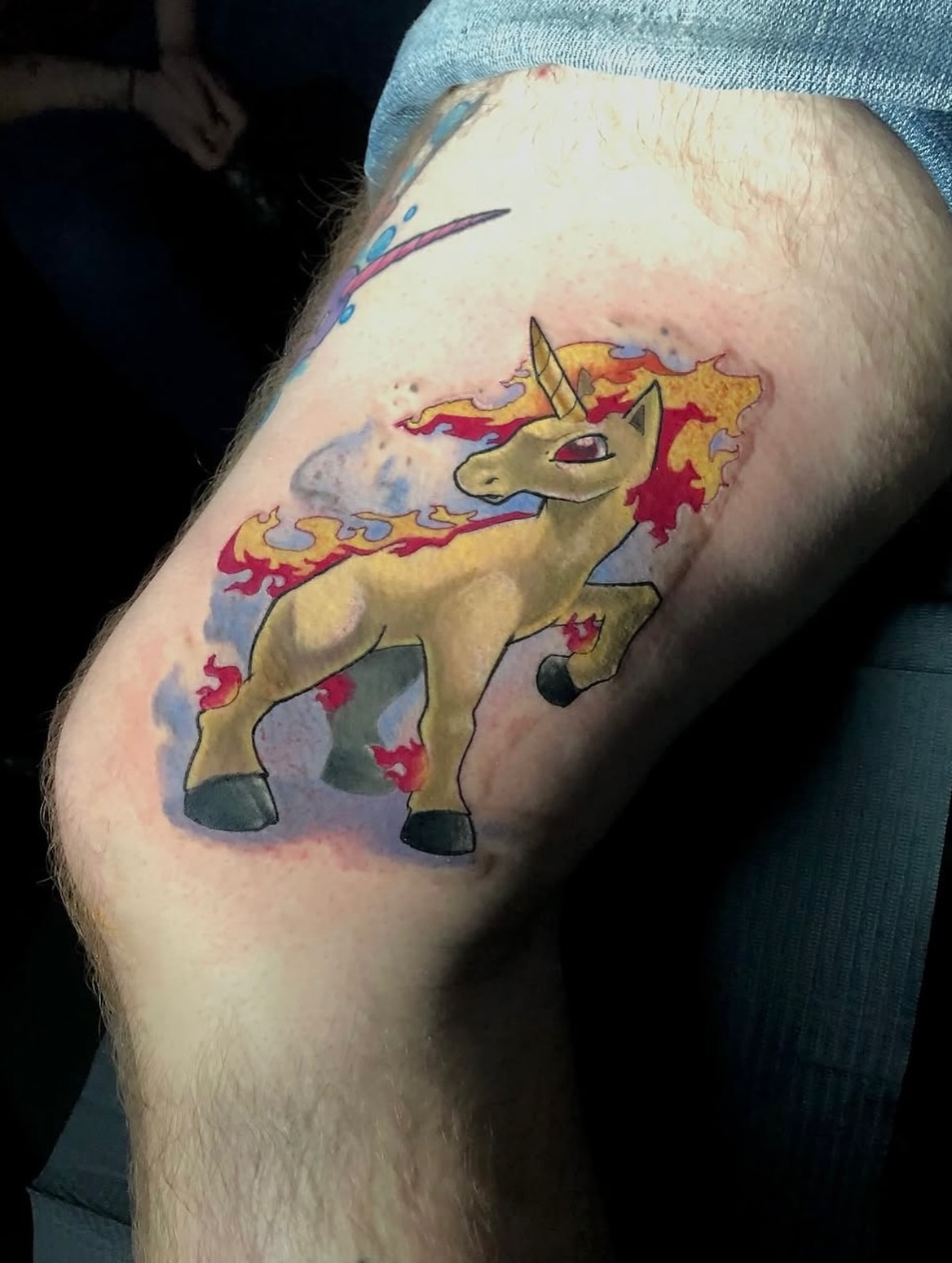 Flaming unicorn new school tattoo on the forearm by Frank Miller