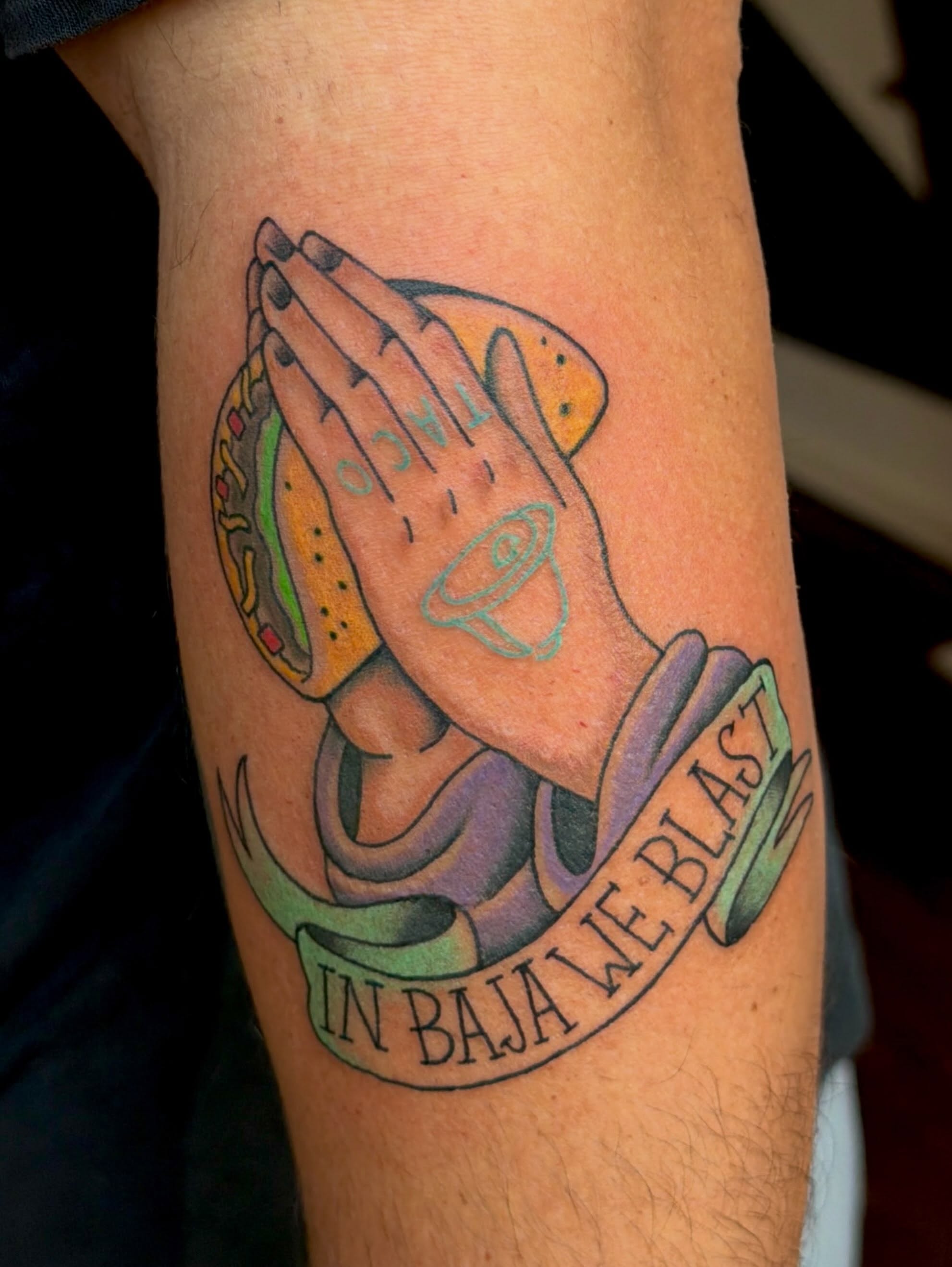 Praying hands with taco American traditional tattoo on the forearm by Alaska ⚜️