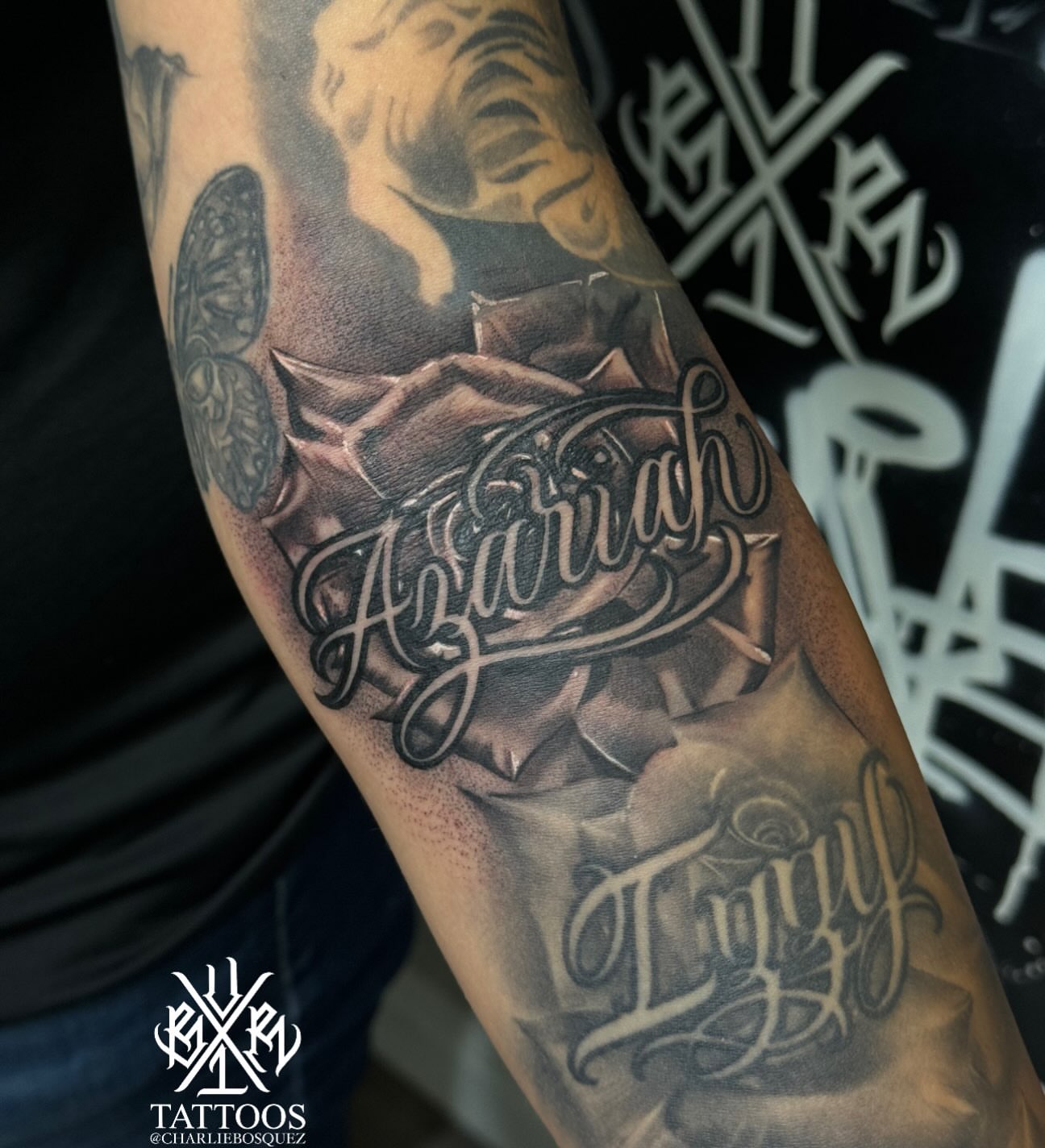 Script lettering black and grey tattoo on the forearm by El Beaver Tattoos