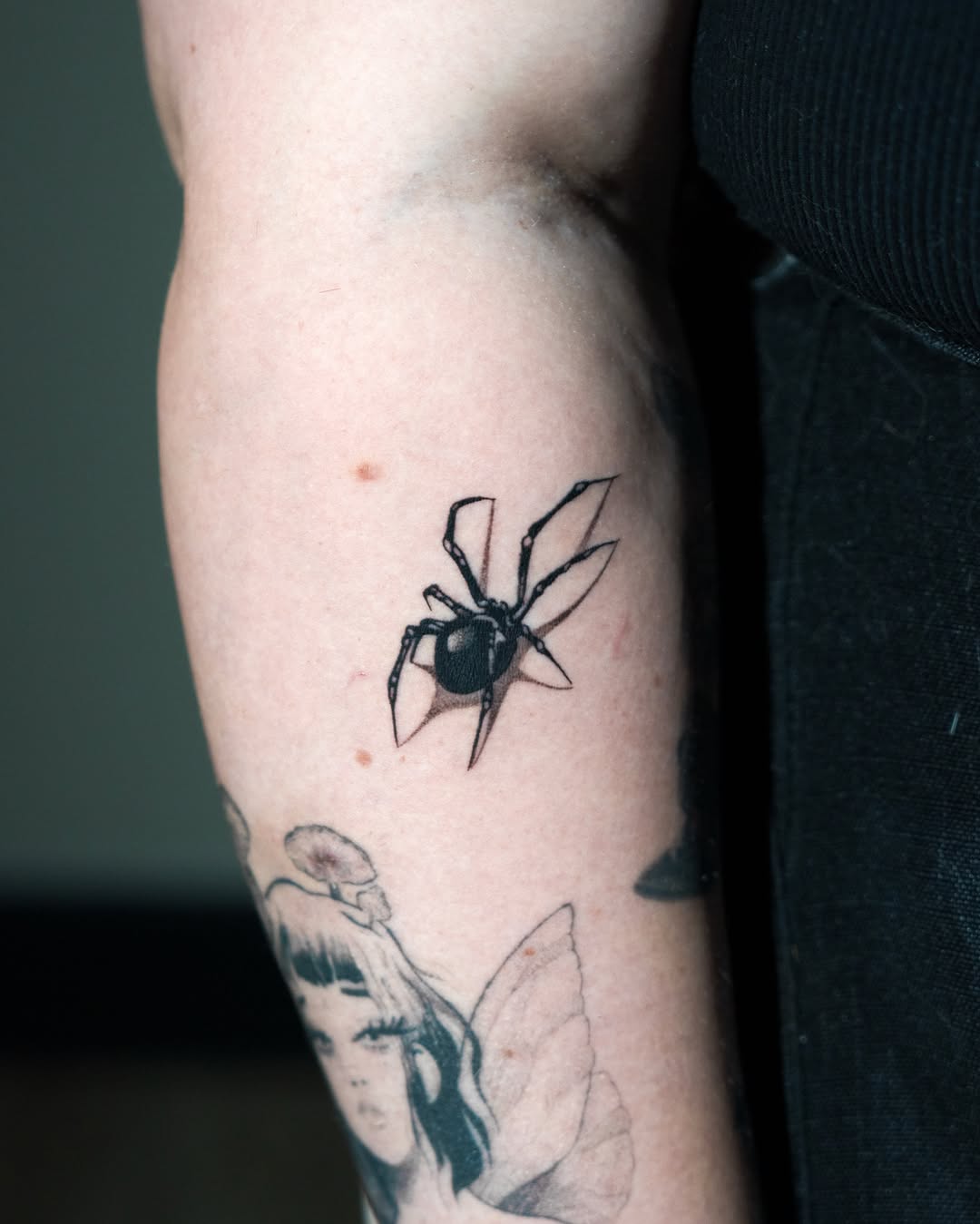 Spider black and grey tattoo on the forearm by Danny Pando