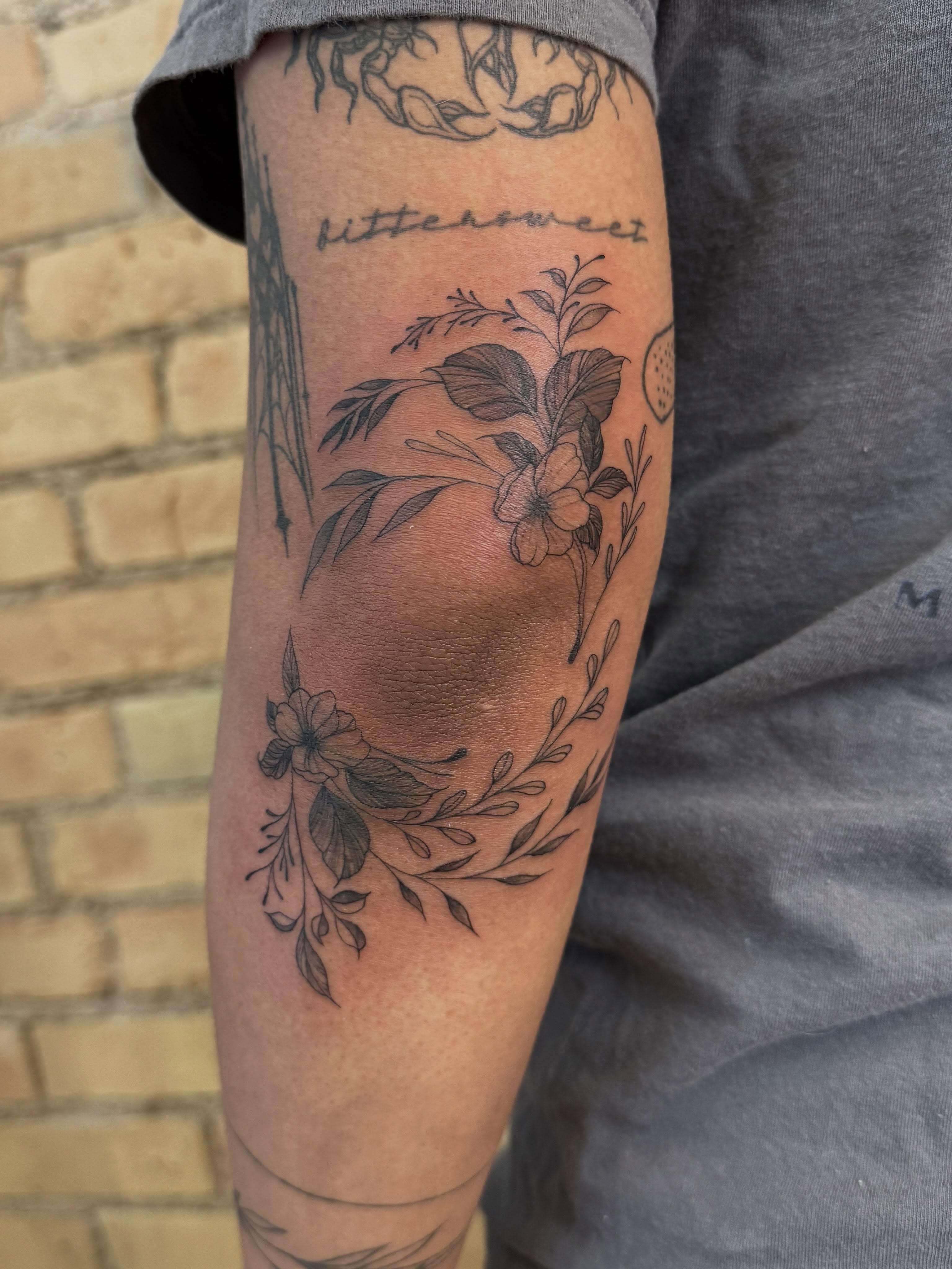 Botanical arrangement black and grey tattoo on the forearm by Dre