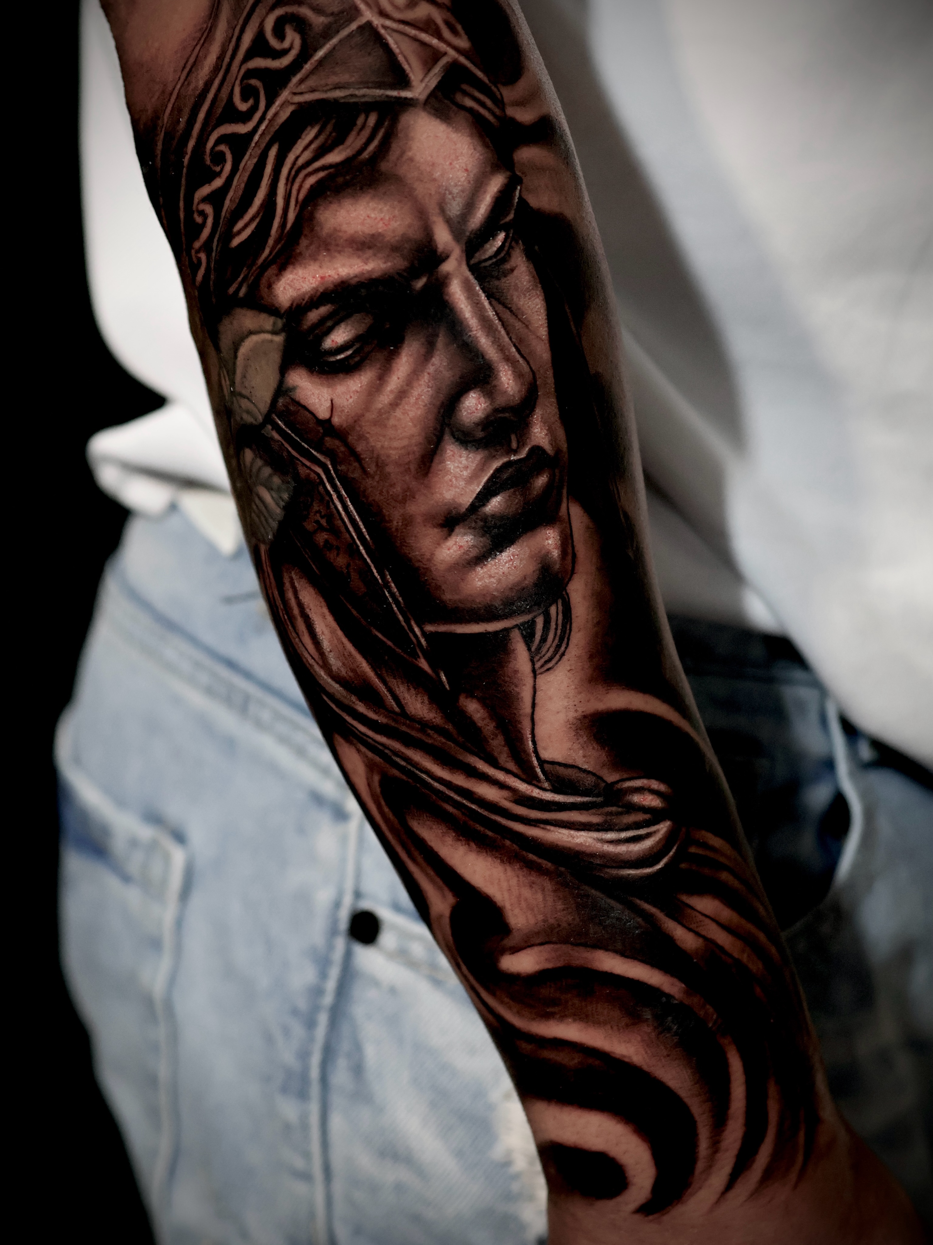 Portrait realism tattoo on the forearm by German Patiño.