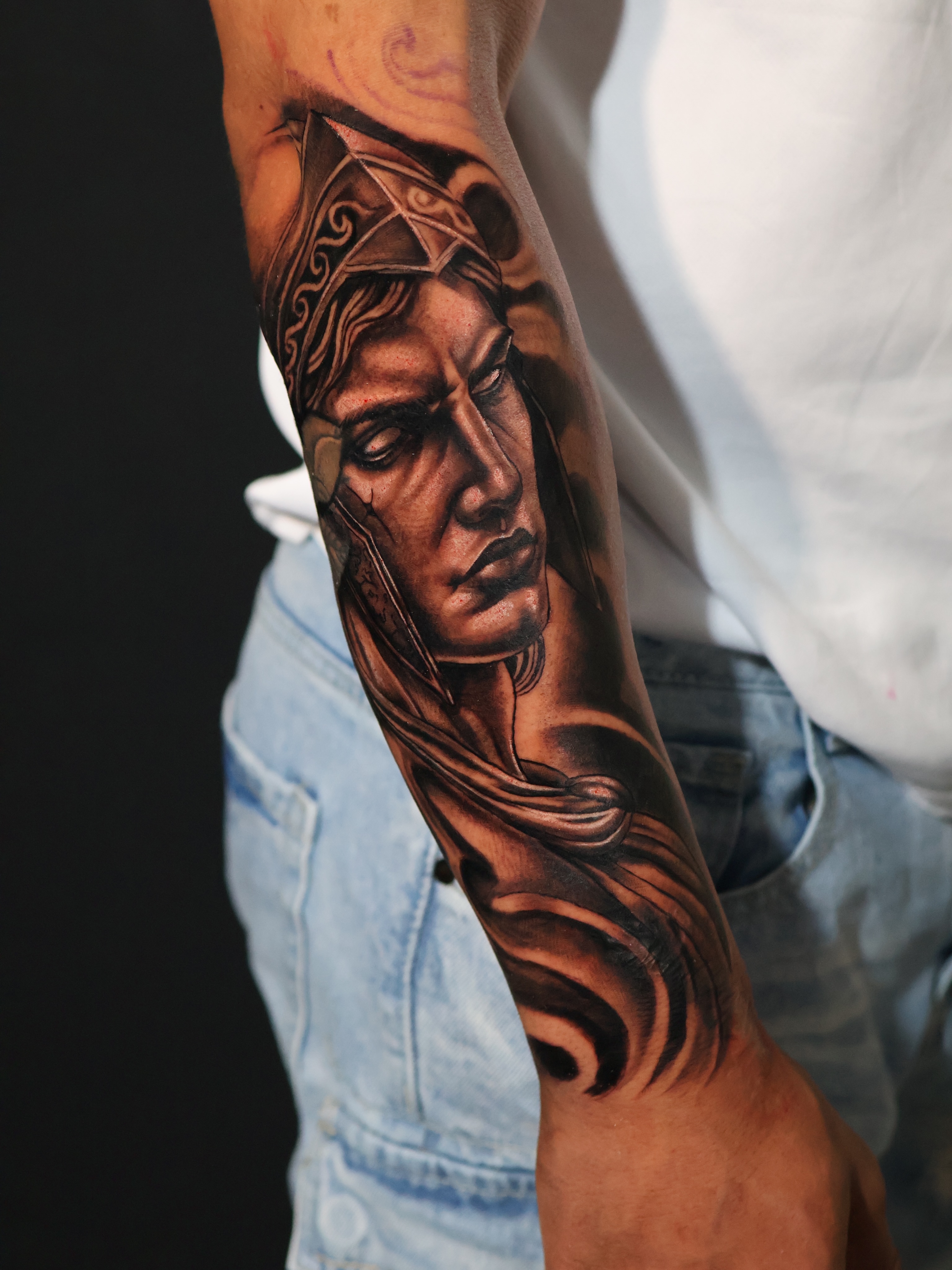 Portrait realism tattoo on the forearm by German Patiño.