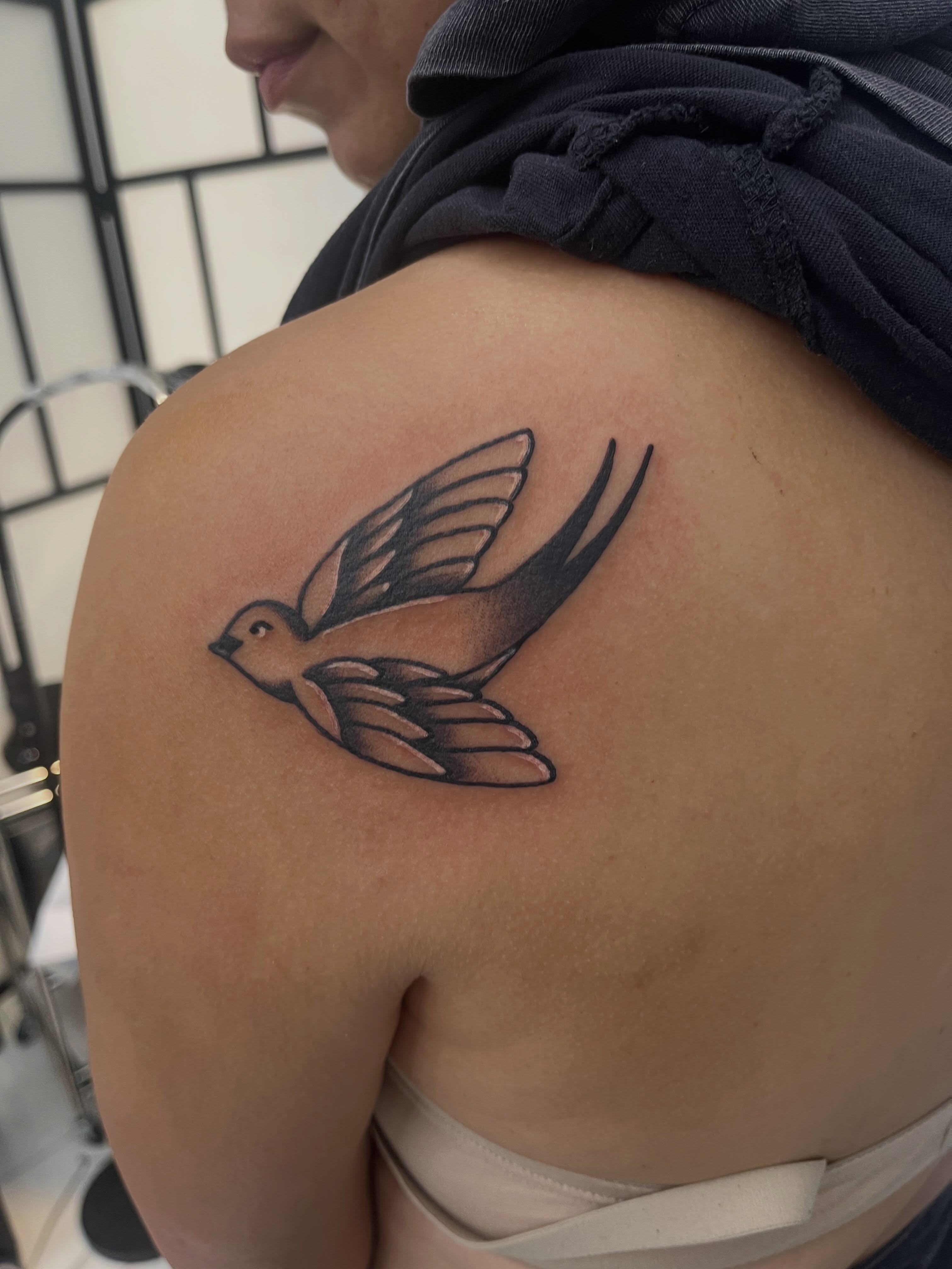 Swallow black and grey tattoo on the shoulder by Sour Tattoo, Somerville, Massachusetts