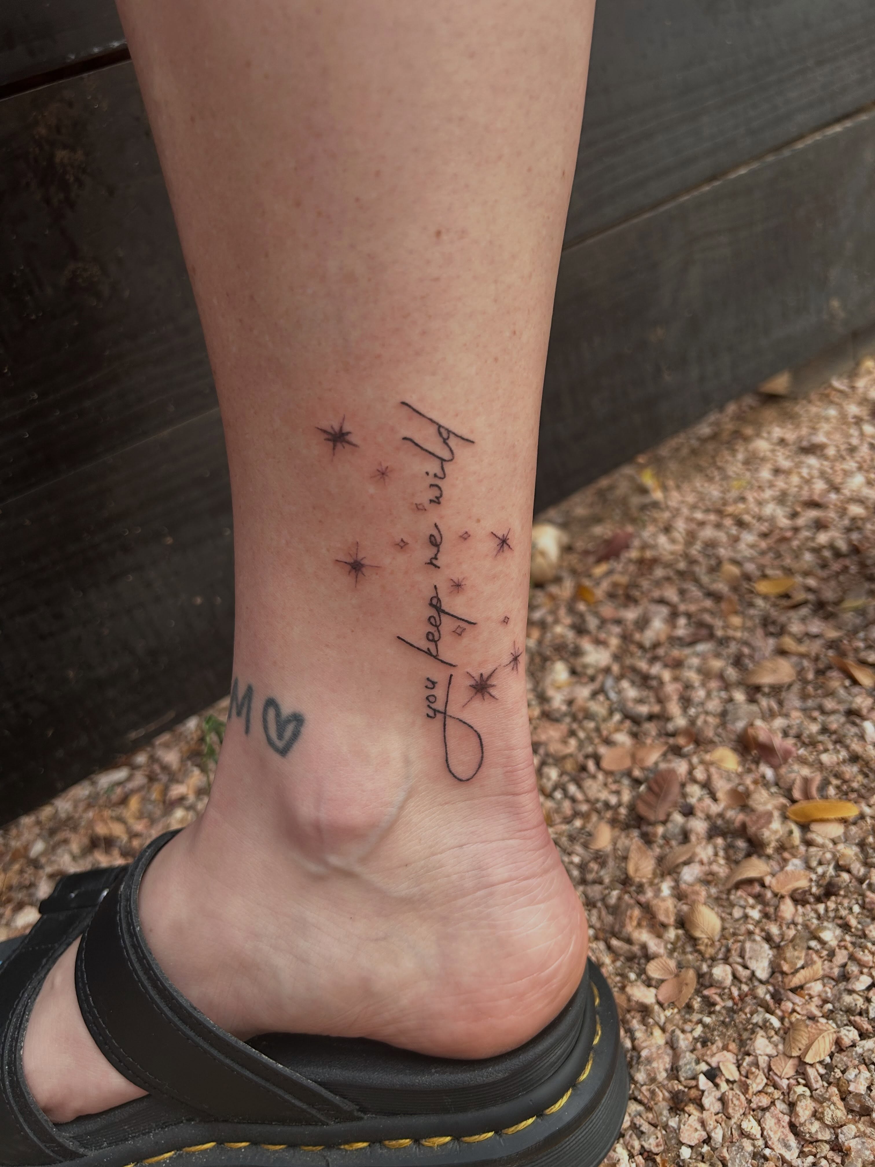 You keep me wild lettering script tattoo on the foot by Miss Katie