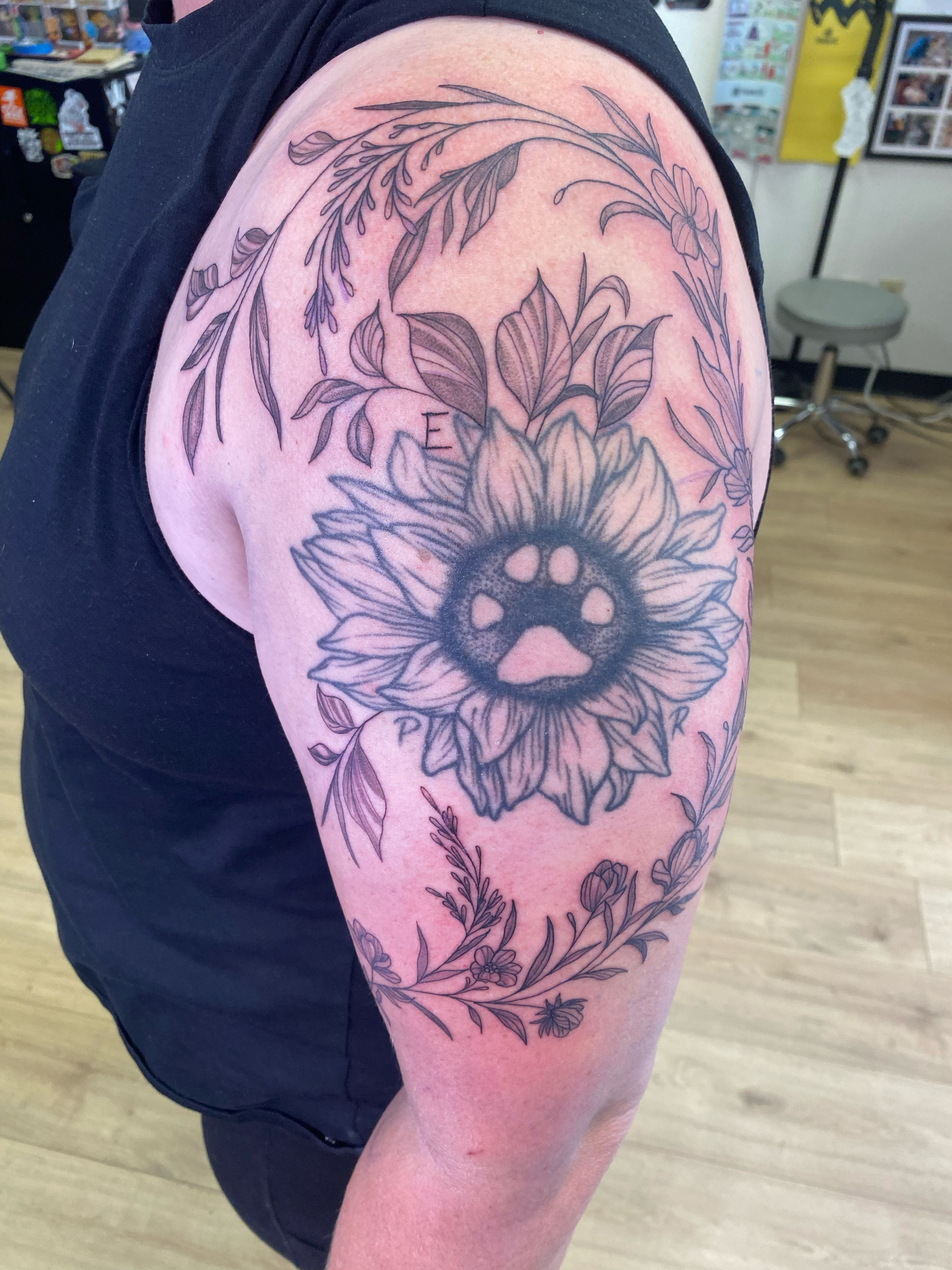 Sunflower black and grey tattoo on the shoulder by Katie Leeper