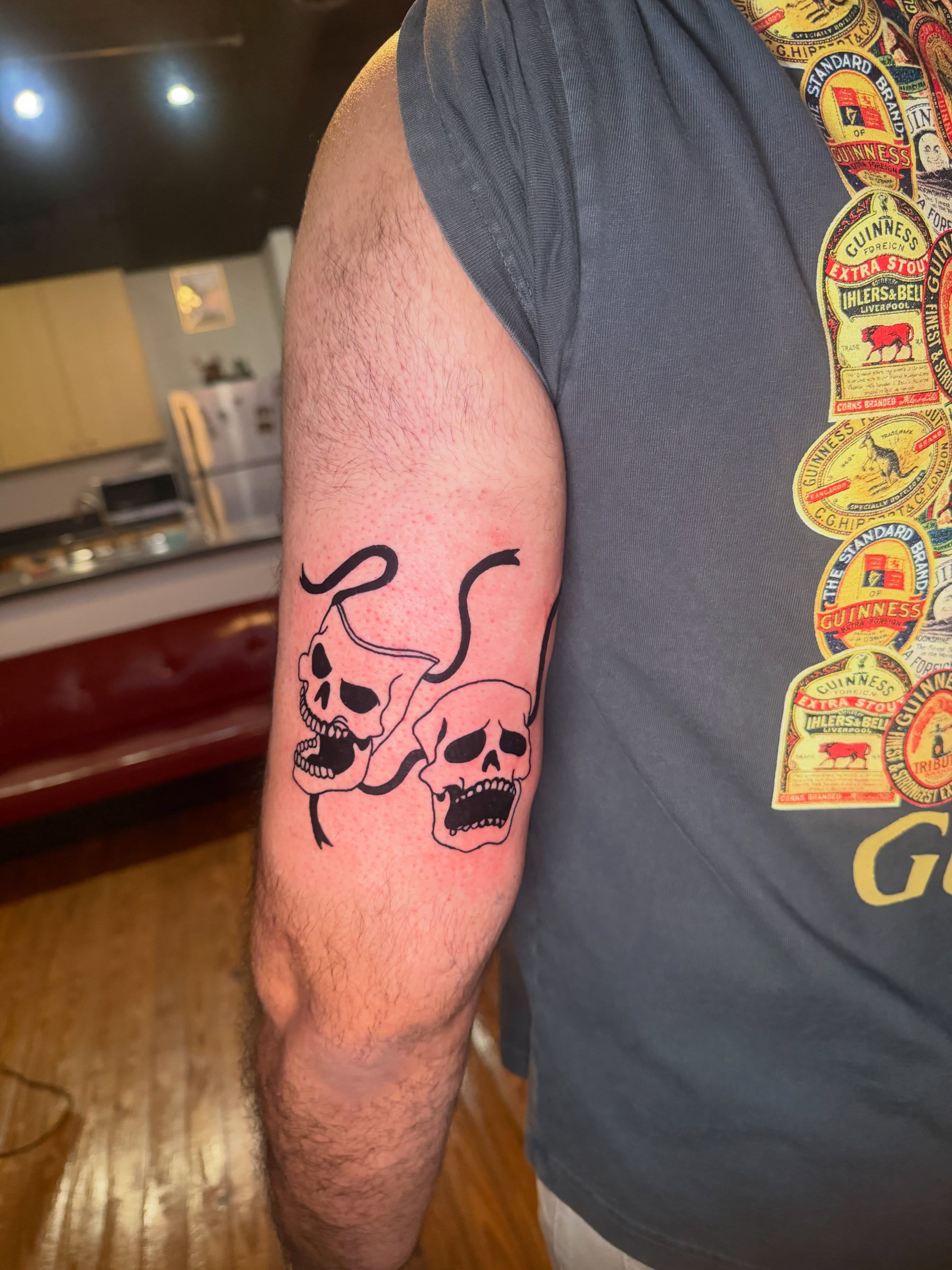 Skulls and snake black and grey tattoo on the forearm by Jose Javier