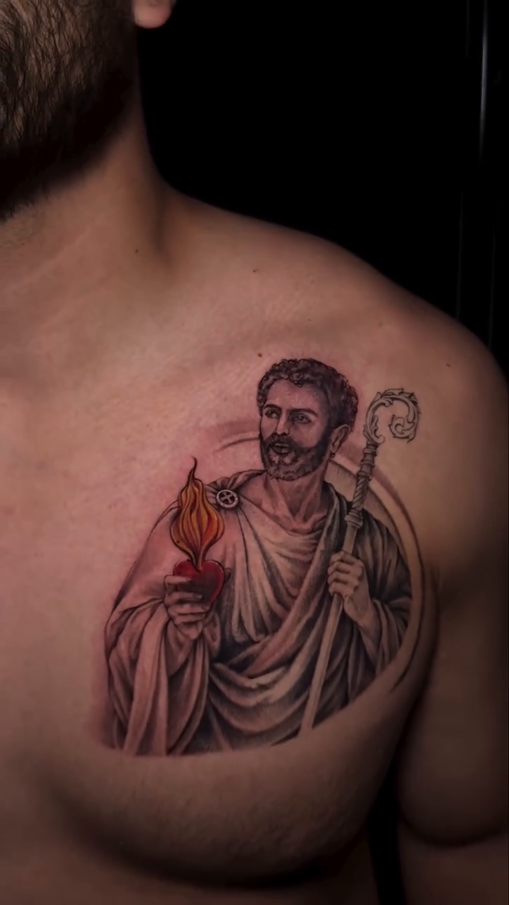 Saint holding a flame and staff realism tattoo by Dani B.