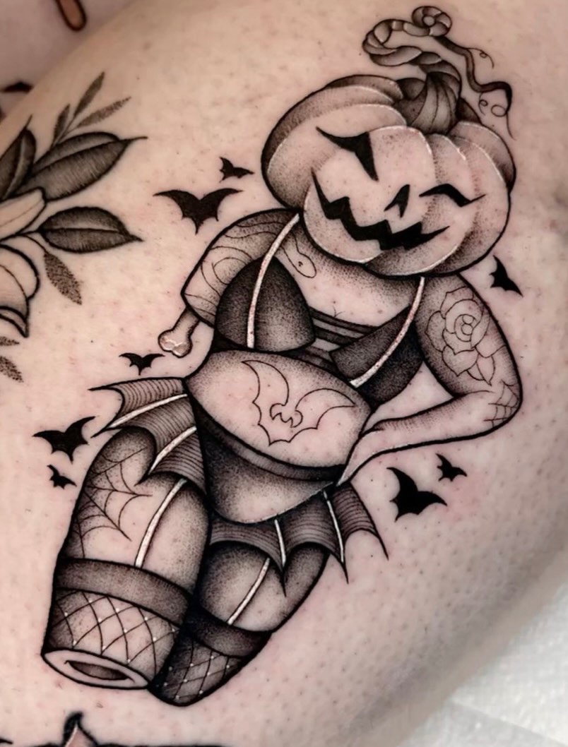 Jack-o'-lantern black and grey tattoo on the thigh by Jazz Walker