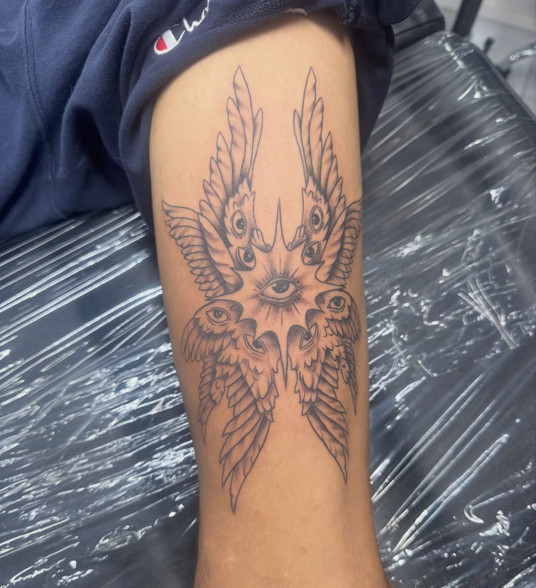 Eyes and birds black and grey tattoo on the thigh by James Howell