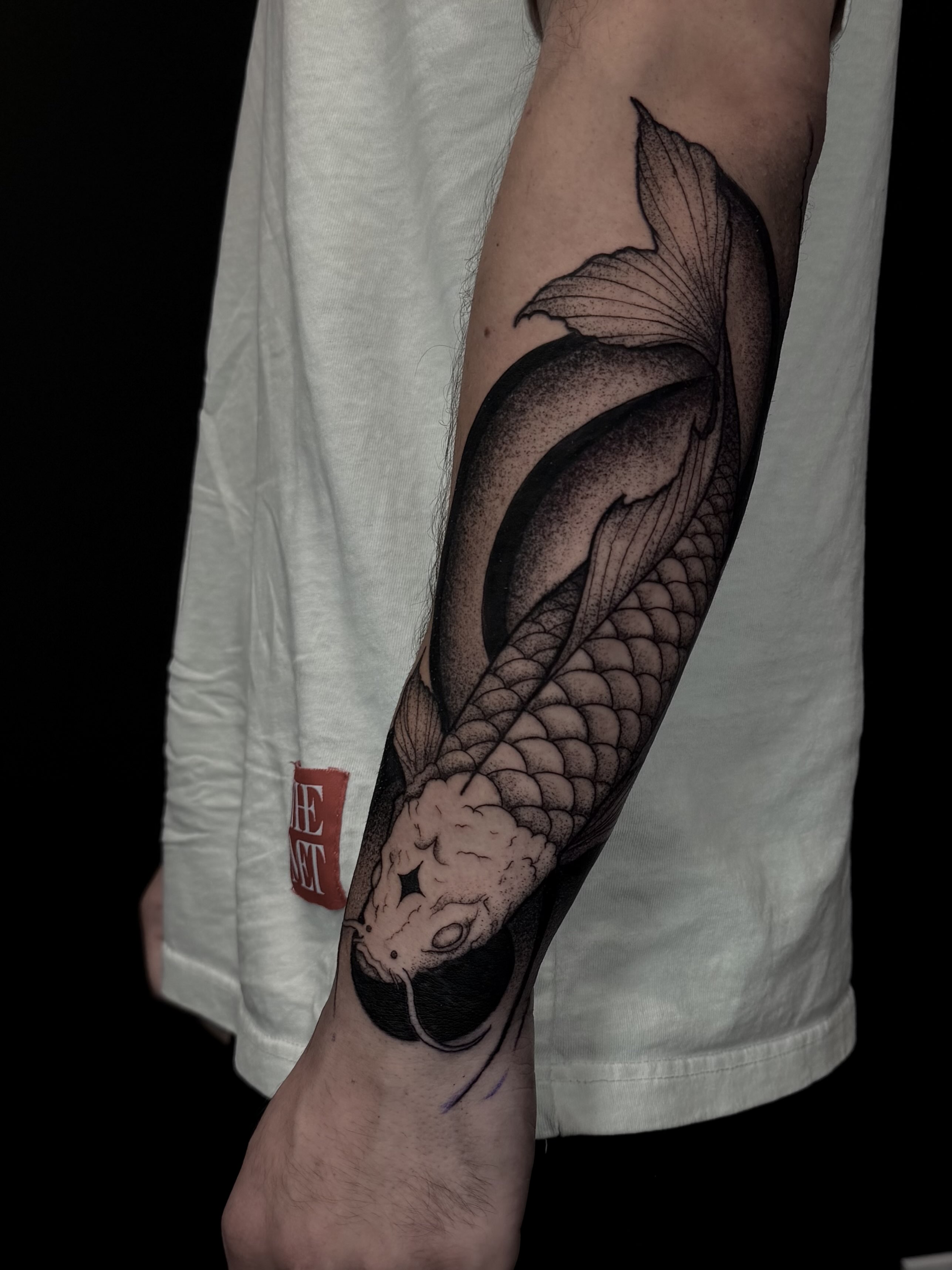 Koi fish dotwork tattoo on the forearm by Sebastián Vallejo