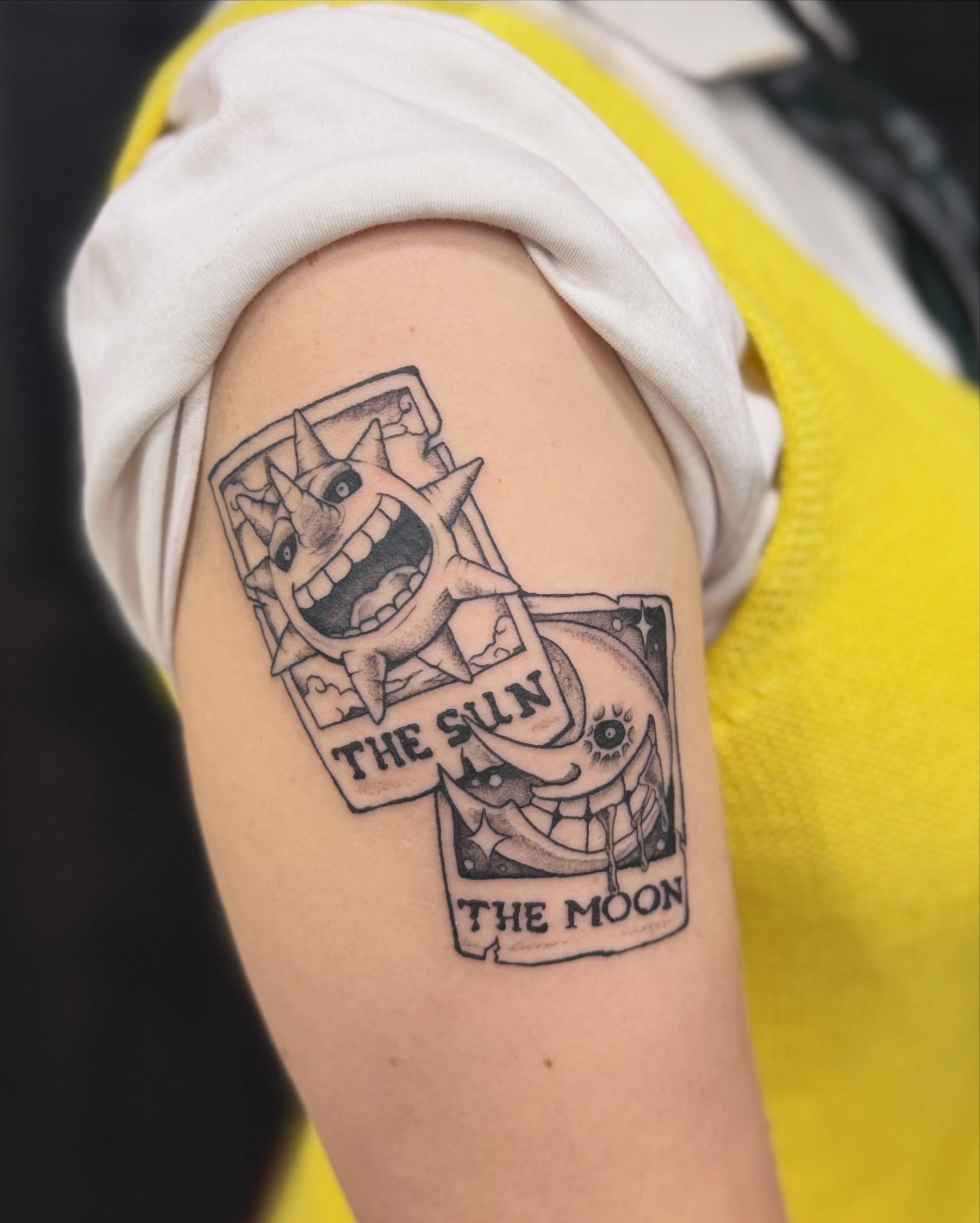 Tarot cards black and grey tattoo on the upper arm by Rebecca Rose