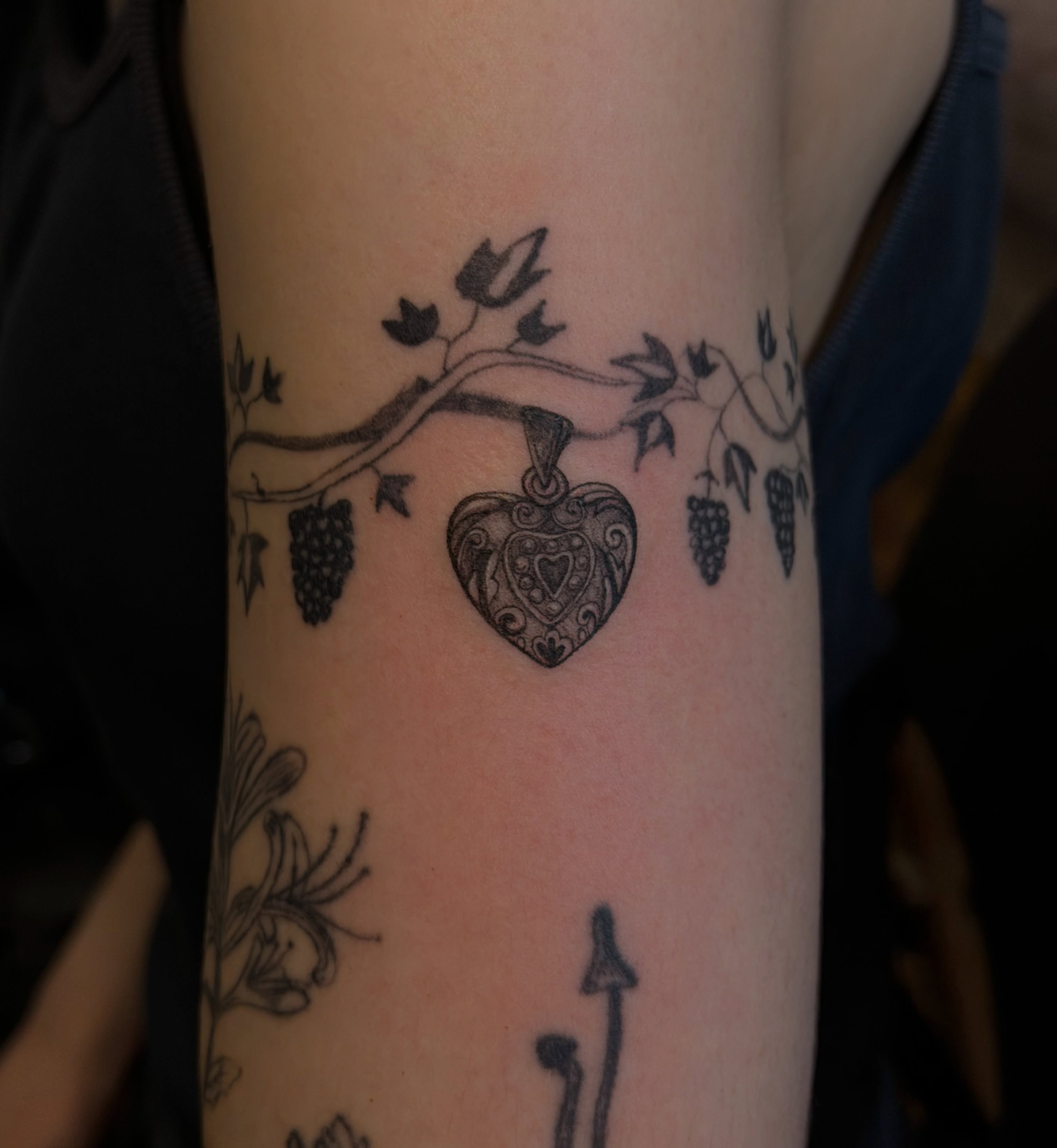 Heart with vine black and grey tattoo on the forearm by Sienna (jj) Hicks