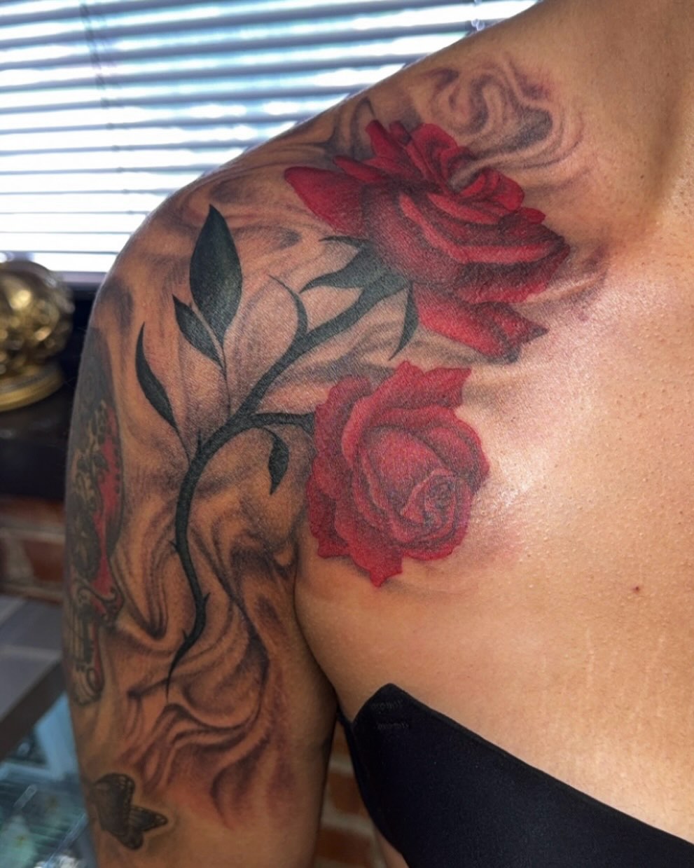 Red roses realism tattoo on the shoulder by Royal Martinez