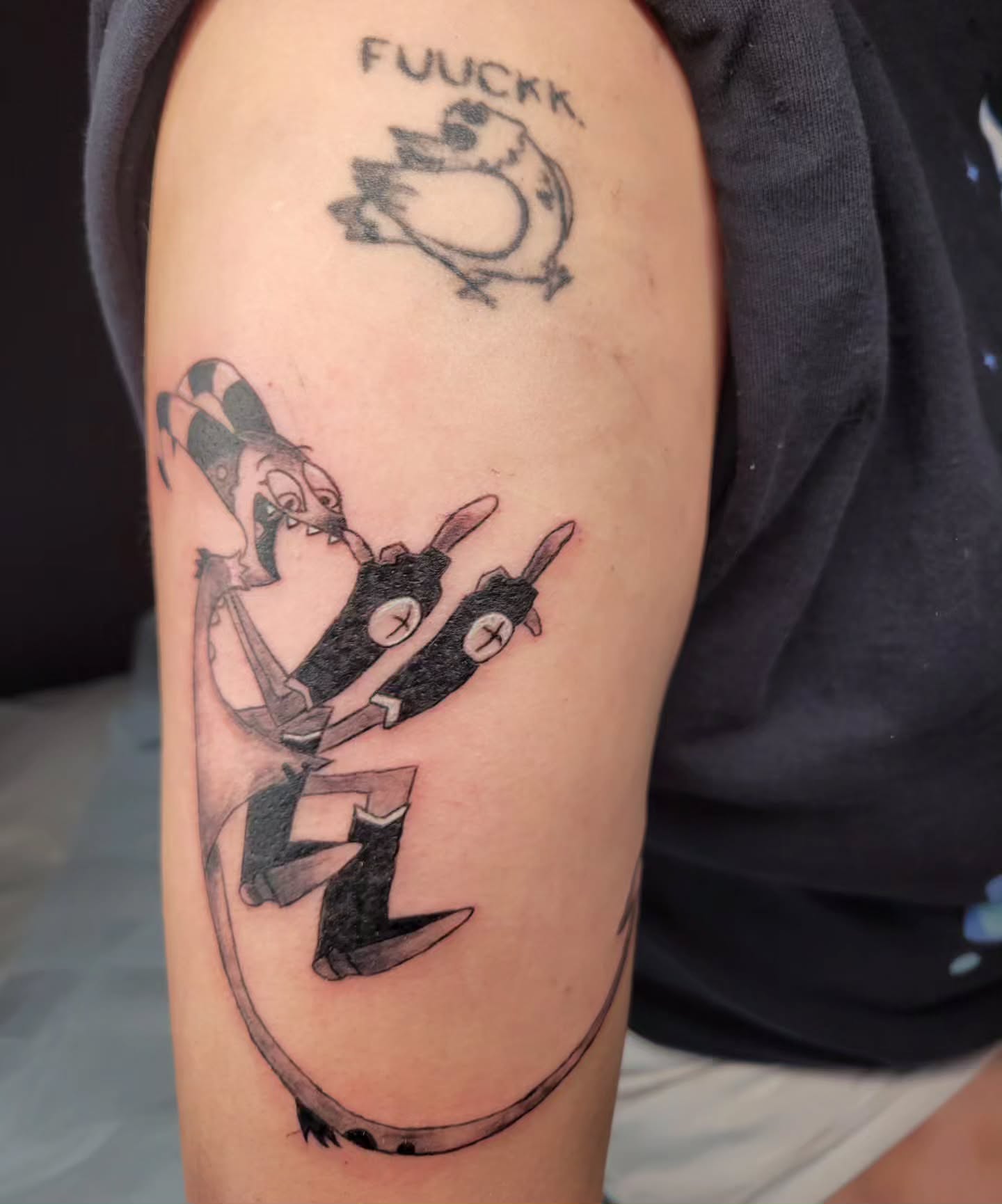 Clown and robot black and grey tattoo on the forearm by Bee