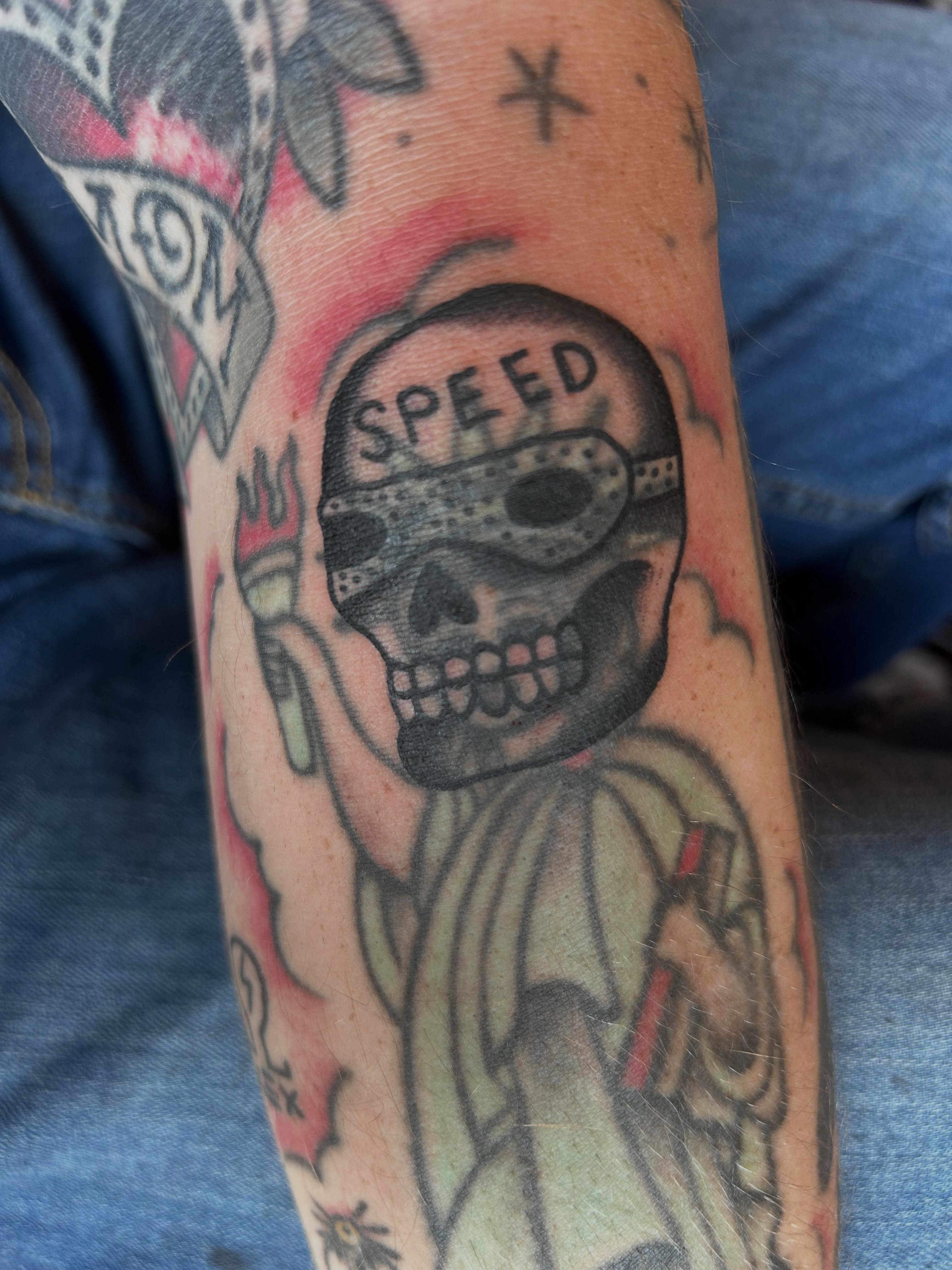 Skull with speed helmet American traditional tattoo on the forearm by Alex Lang