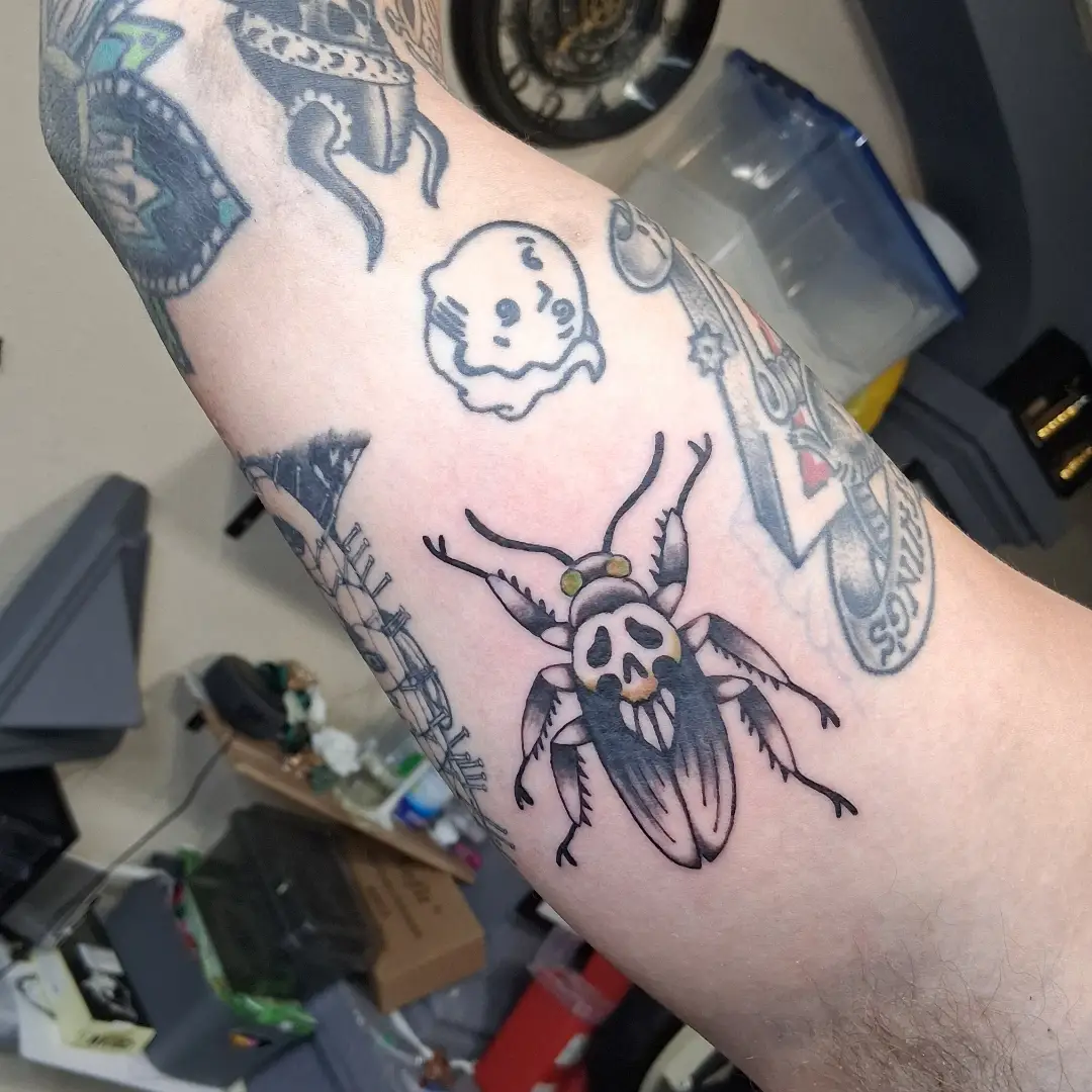 Skull beetle black and grey tattoo on the forearm by Tanya Tattoota