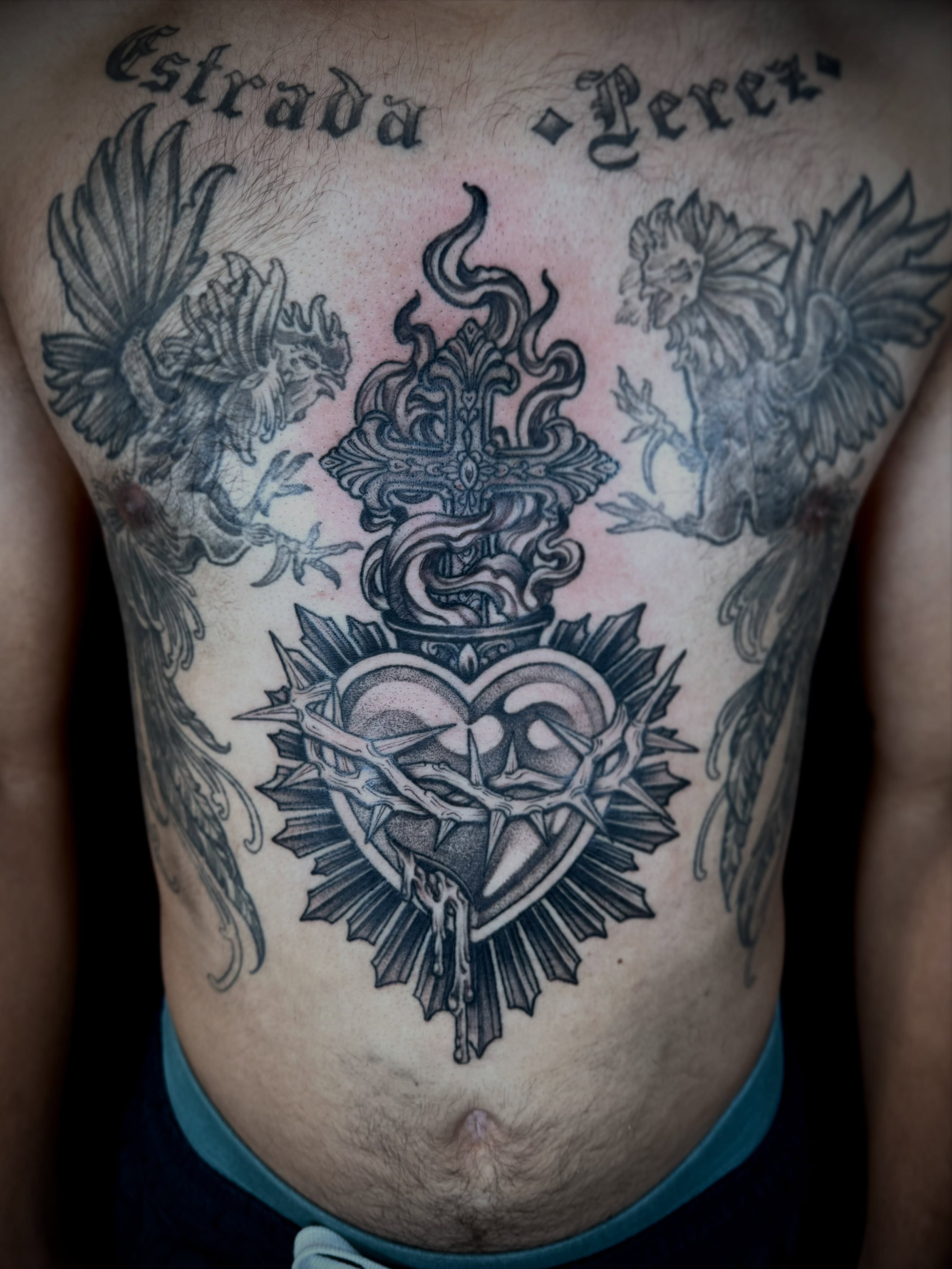 Heart with cross black and grey tattoo on the chest by 🏵