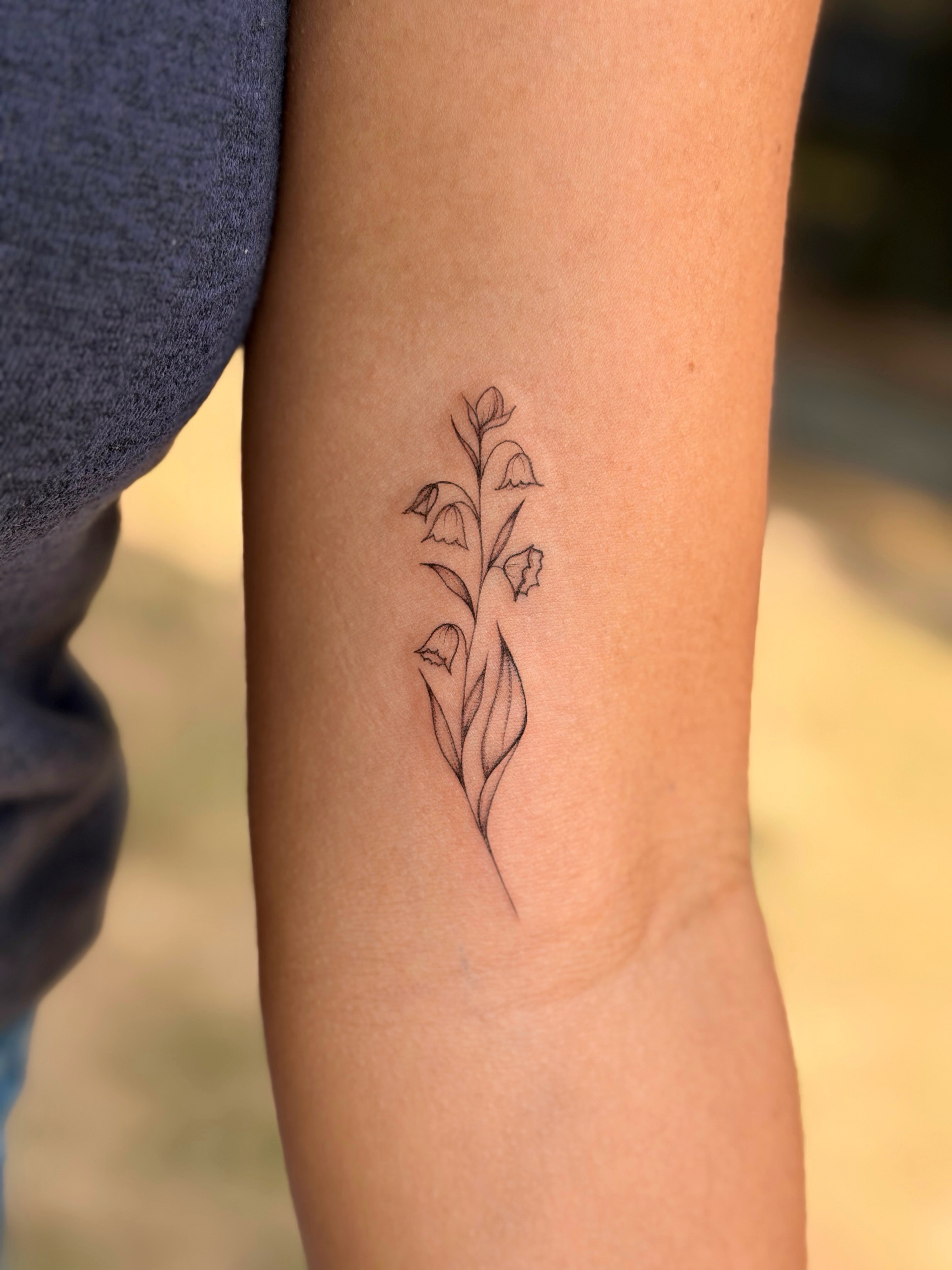 Bell flowers fine line tattoo on the forearm by Emily Velletta, Huntersville, North Carolina