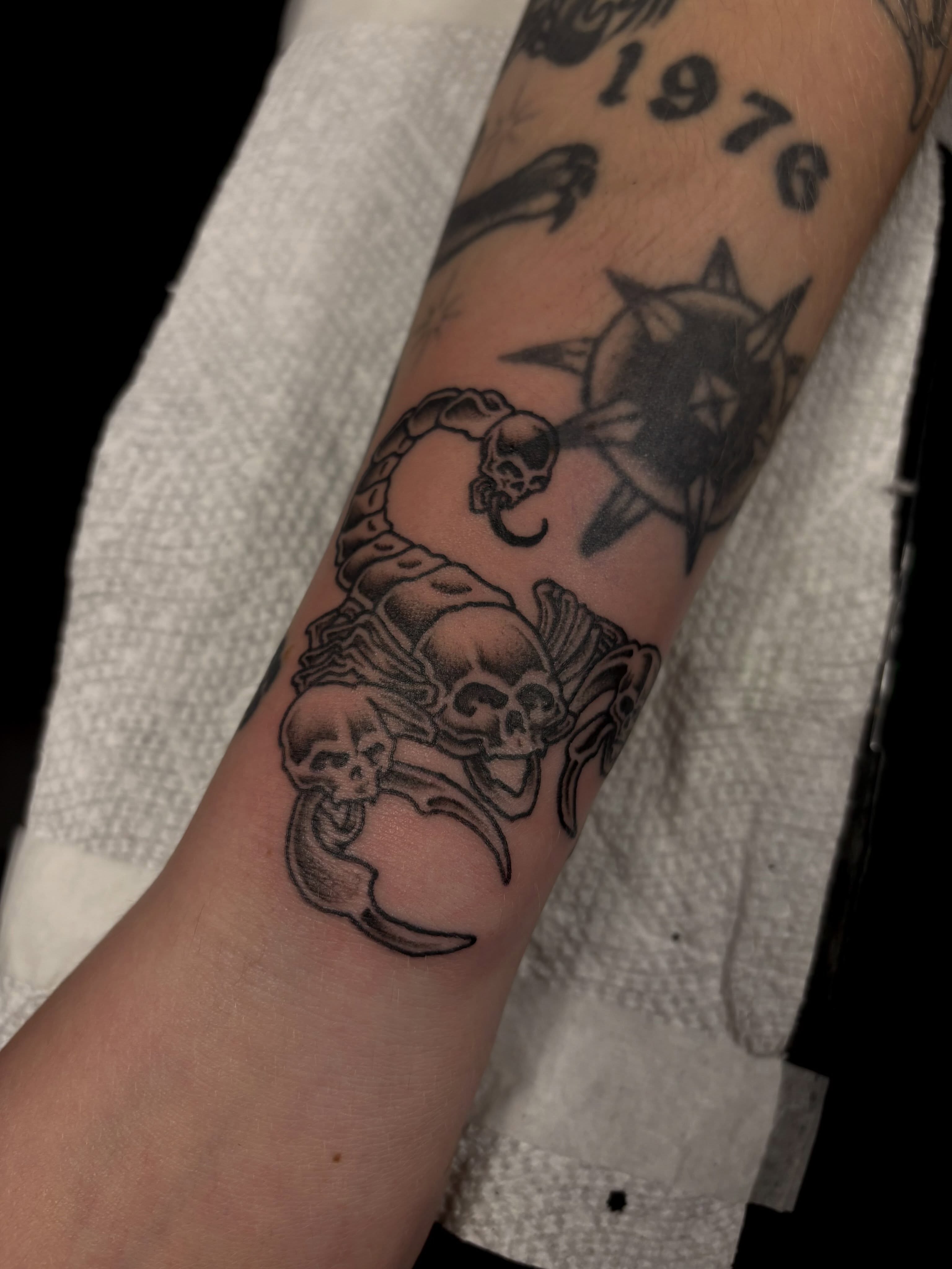Skulls and crescent moons black and grey tattoo on the forearm by Alyssa L'Heureux🕴🏼, Los Angeles, California