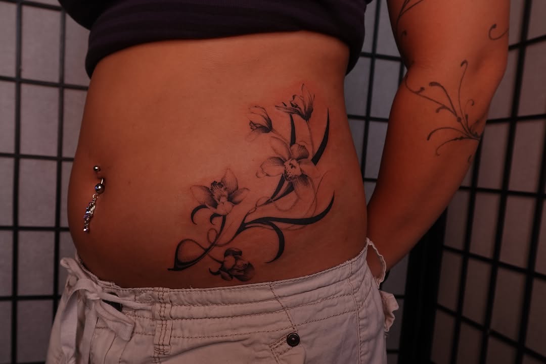 Floral design black and grey tattoo on the torso by jun