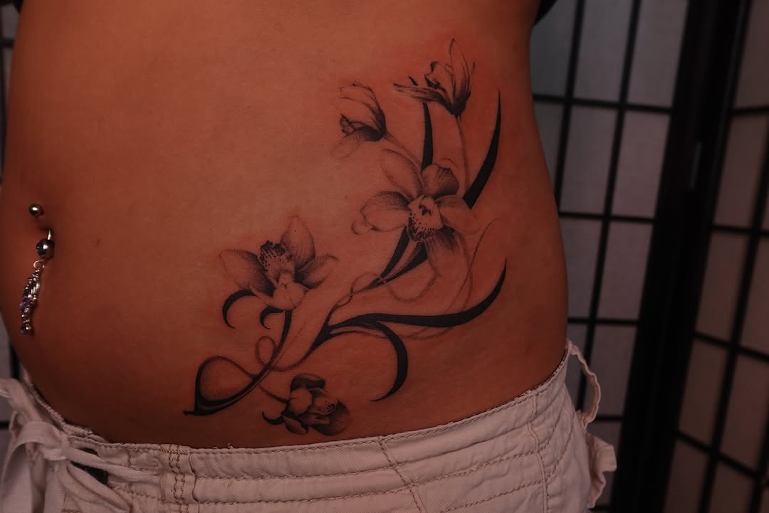Orchids black and grey tattoo on the torso by jun