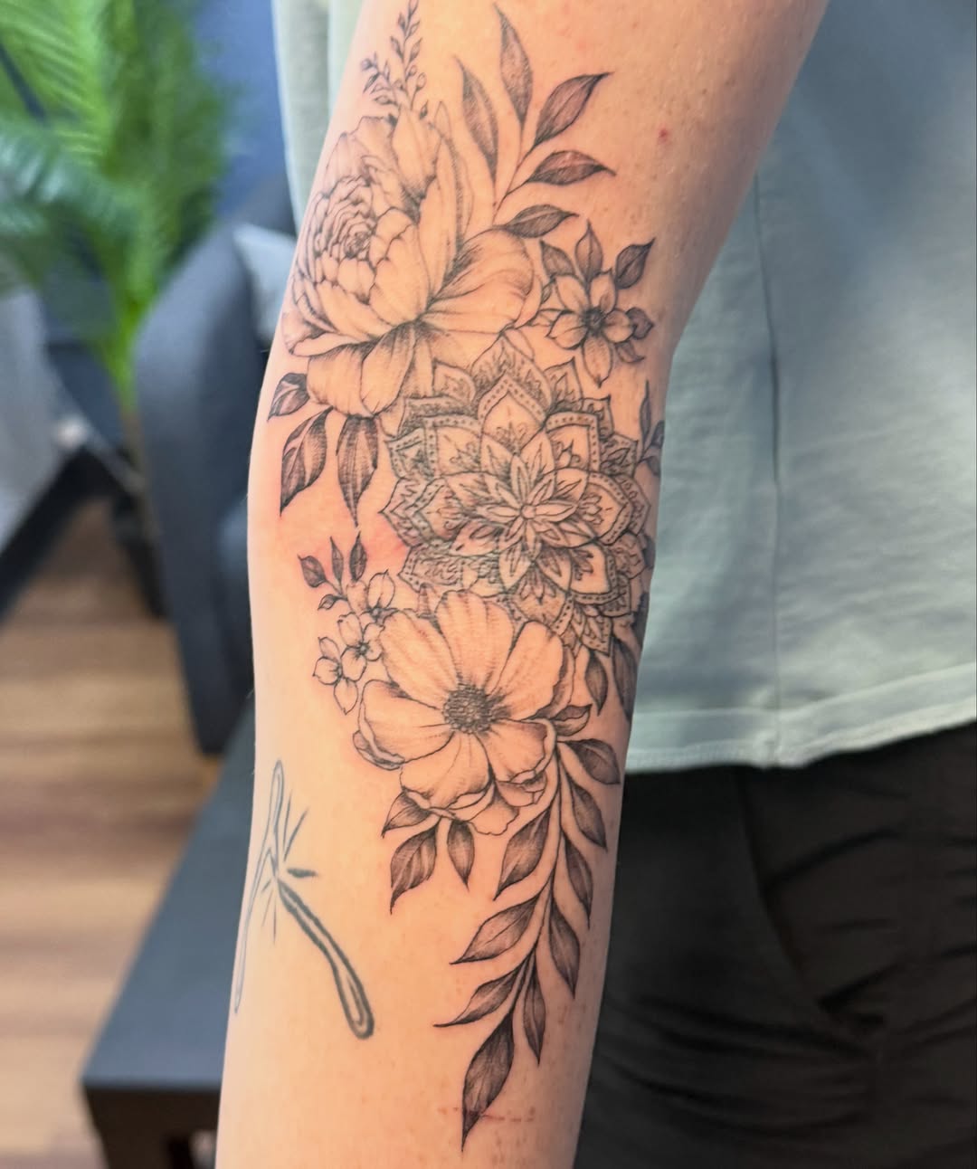 Floral bouquet realism tattoo on the forearm by Tetiana