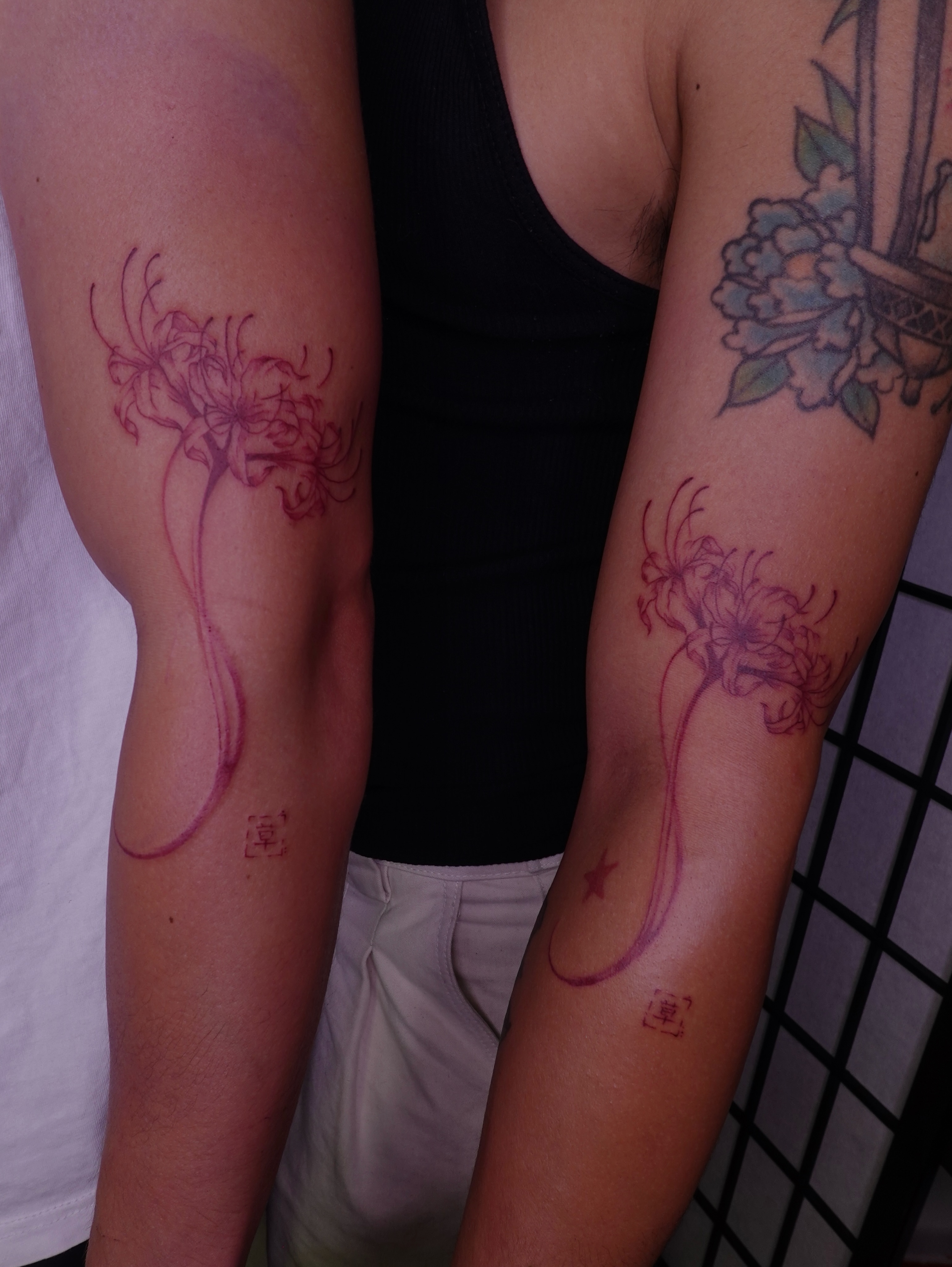 Lily dotwork tattoo on the forearm by jun