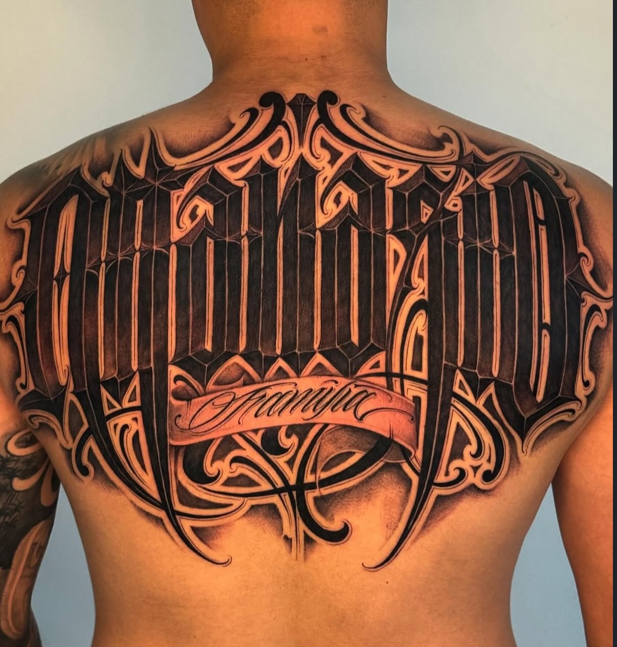 Geometric geometric tattoo on the back by Chicanocustomlettering