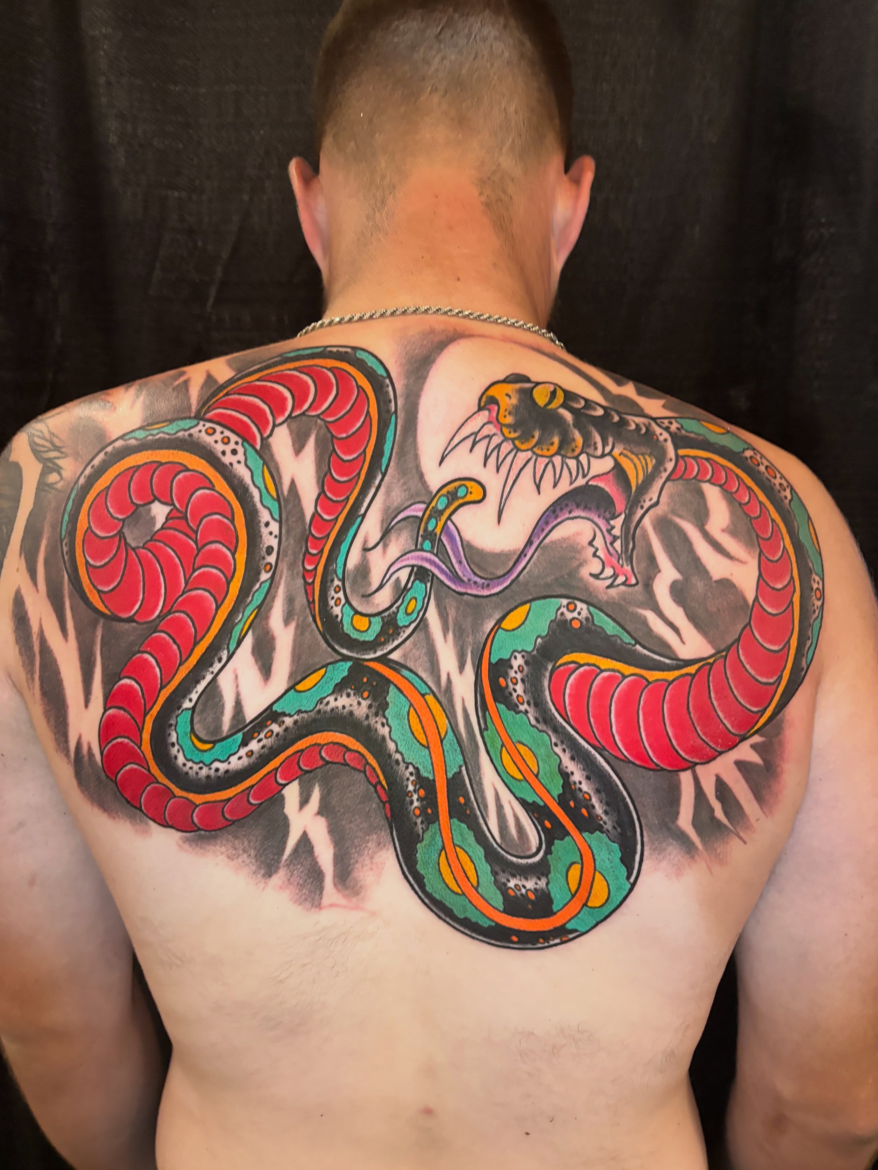 Snake American traditional tattoo on the back by Cleen Rock One