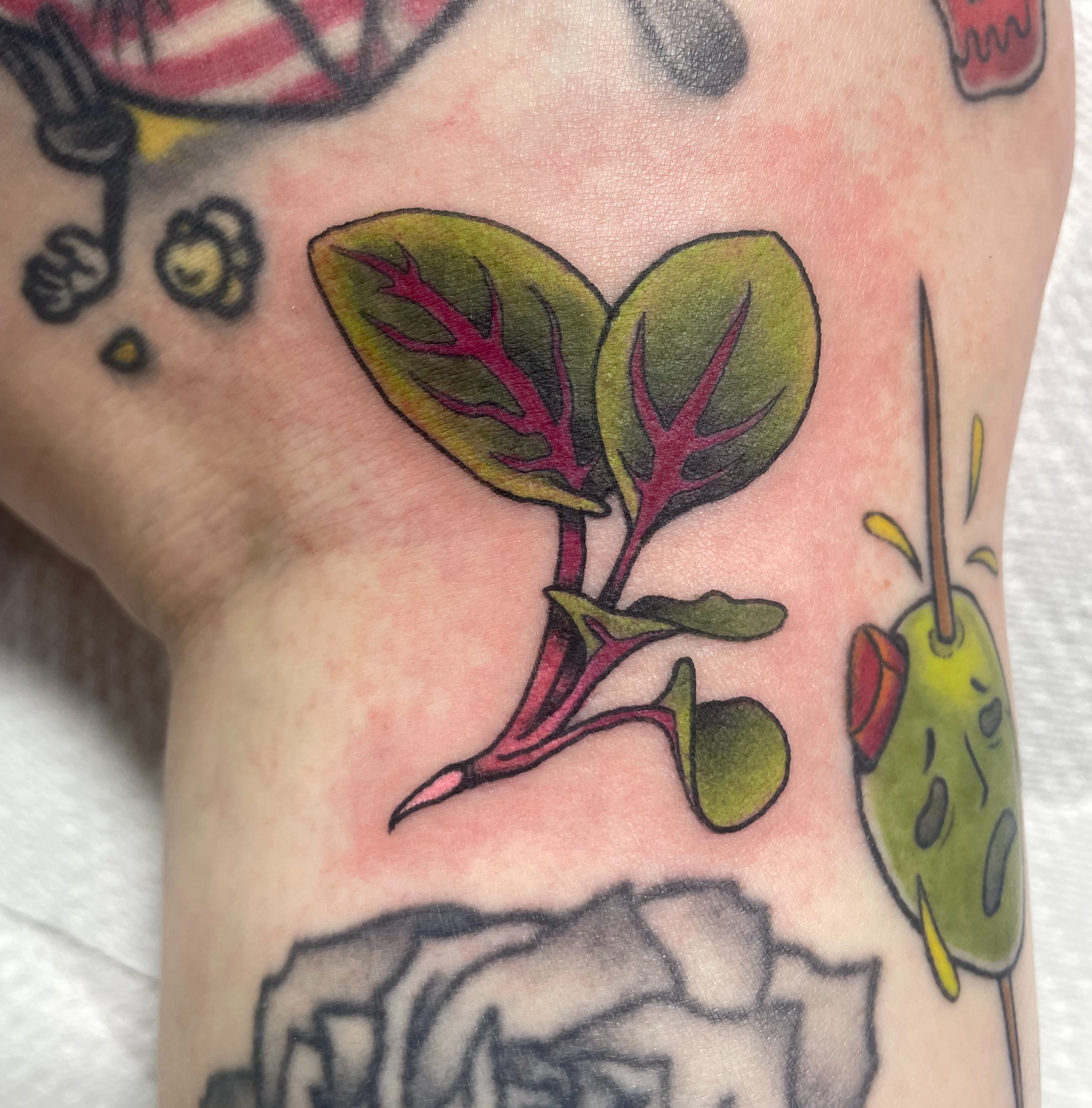 Spinach sprout new school tattoo on the forearm by Eric (EK) Kuldell