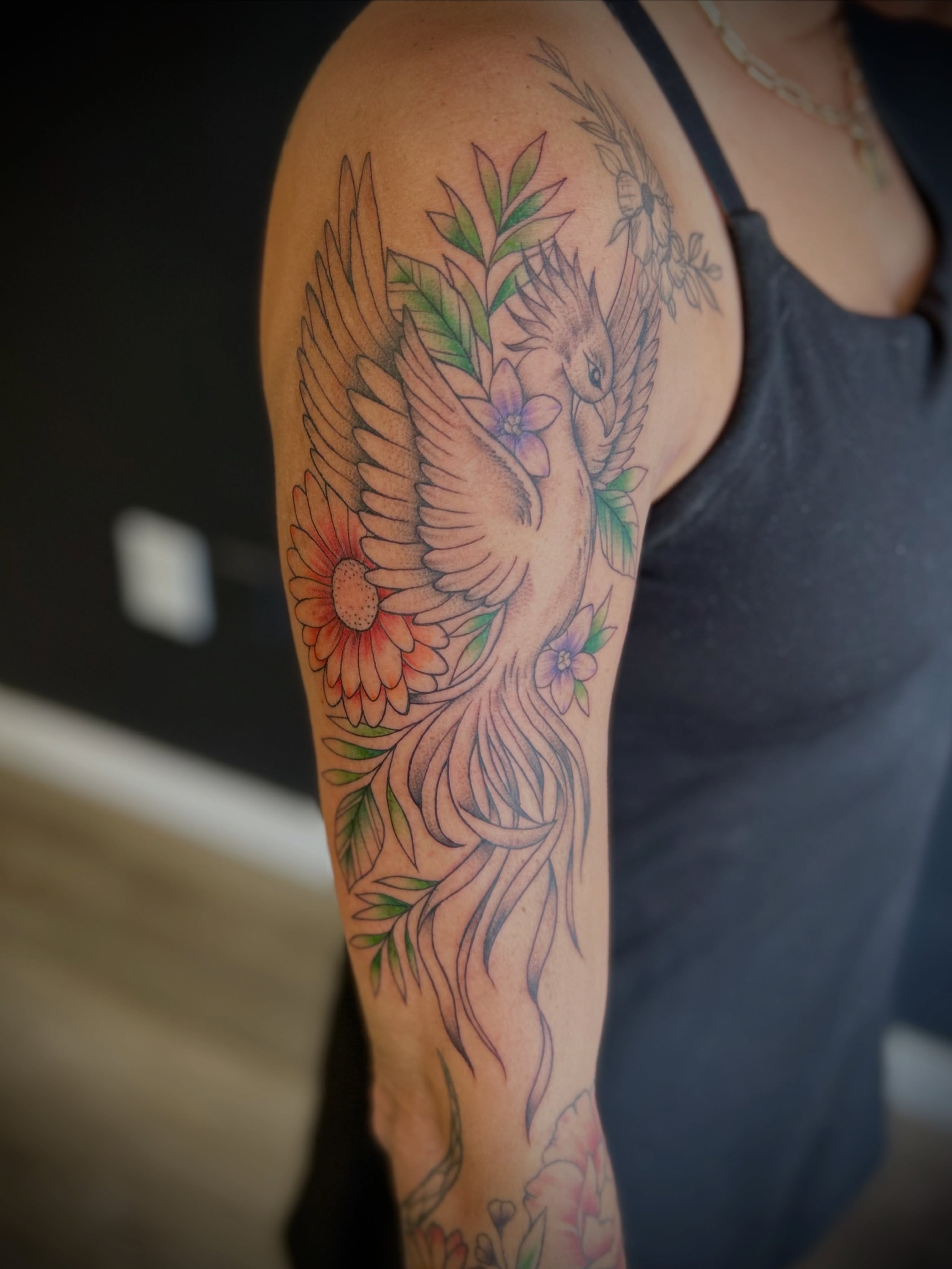Phoenix and flowers American traditional tattoo on the upper arm by Browtique & Ink, Clearwater, Florida