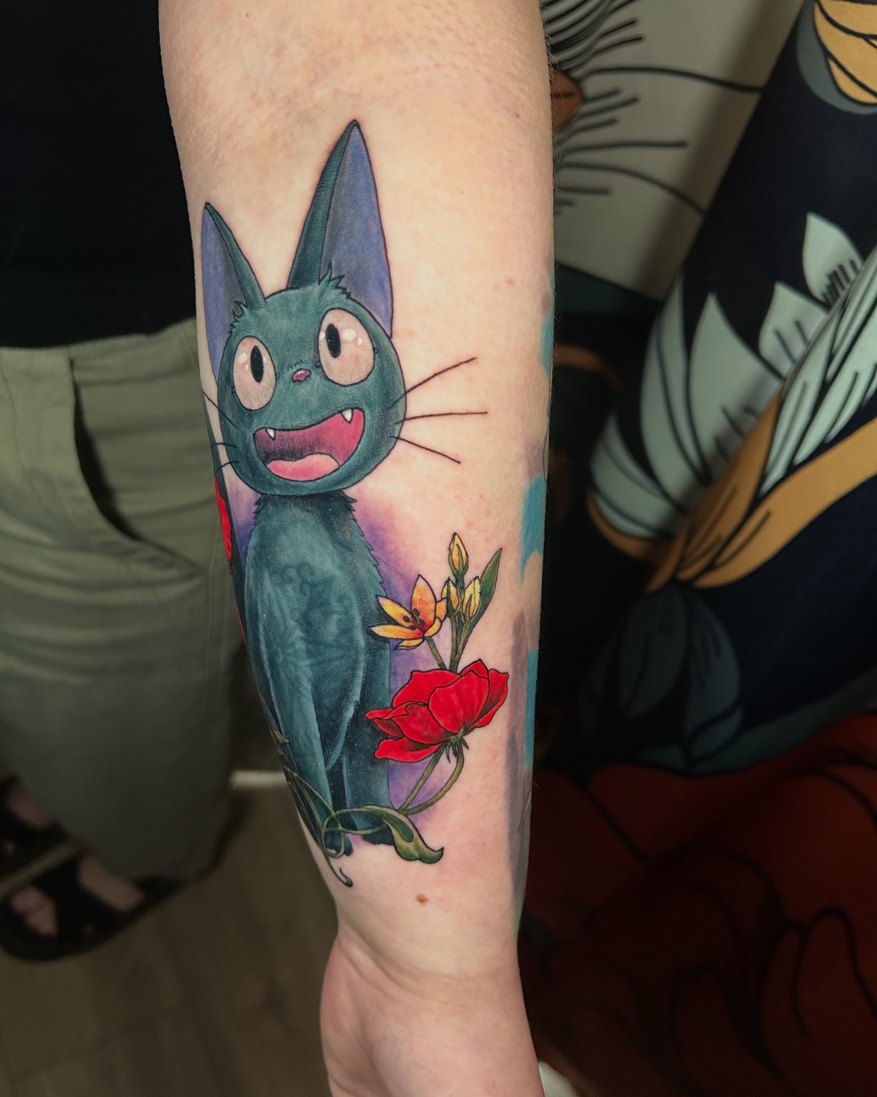 Jiji and flowers anime tattoo on the forearm by Paisley Diaz, Lombard, Illinois