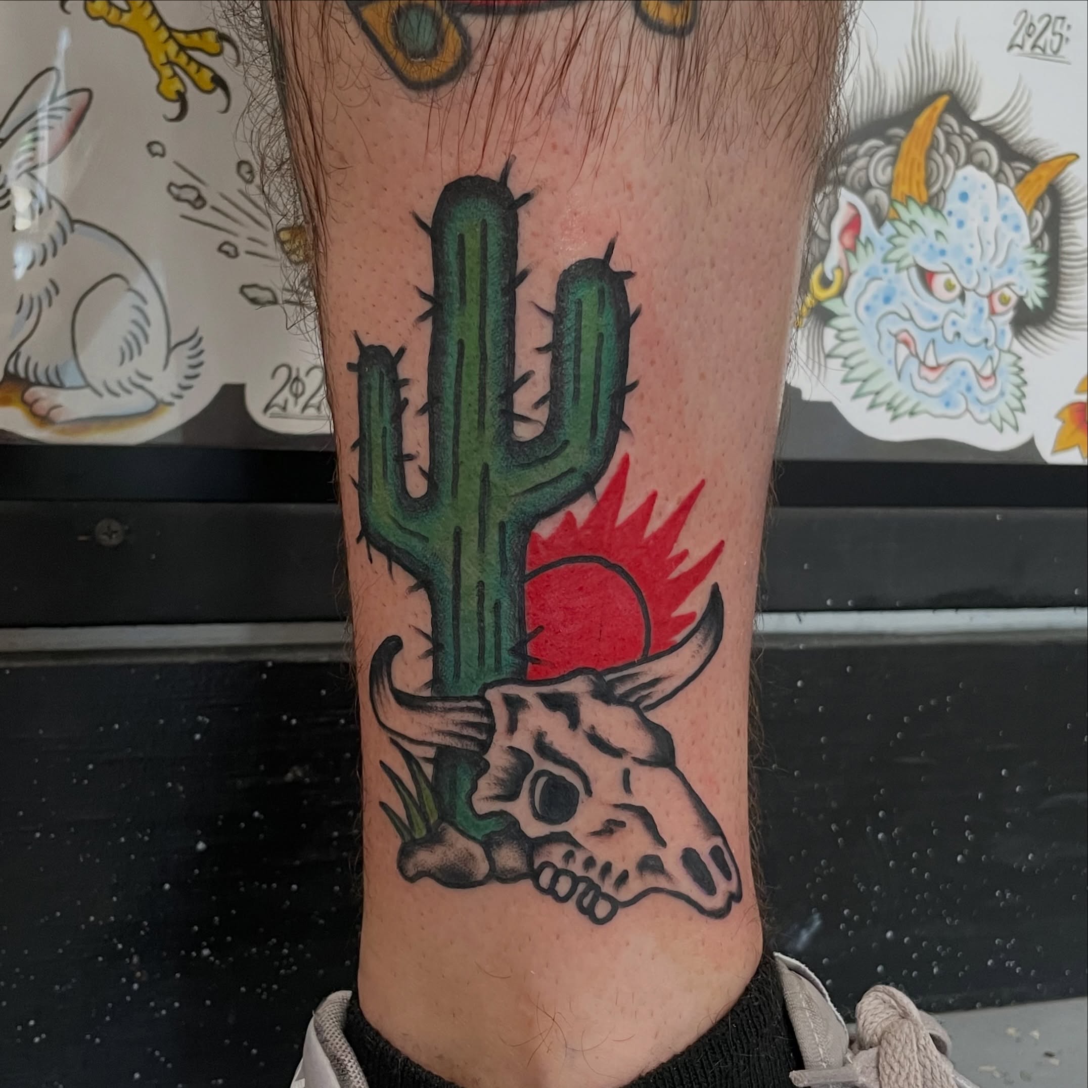 Cactus and bull skull American traditional tattoo on the forearm by Greg De Hoot, Youngsville, North Carolina