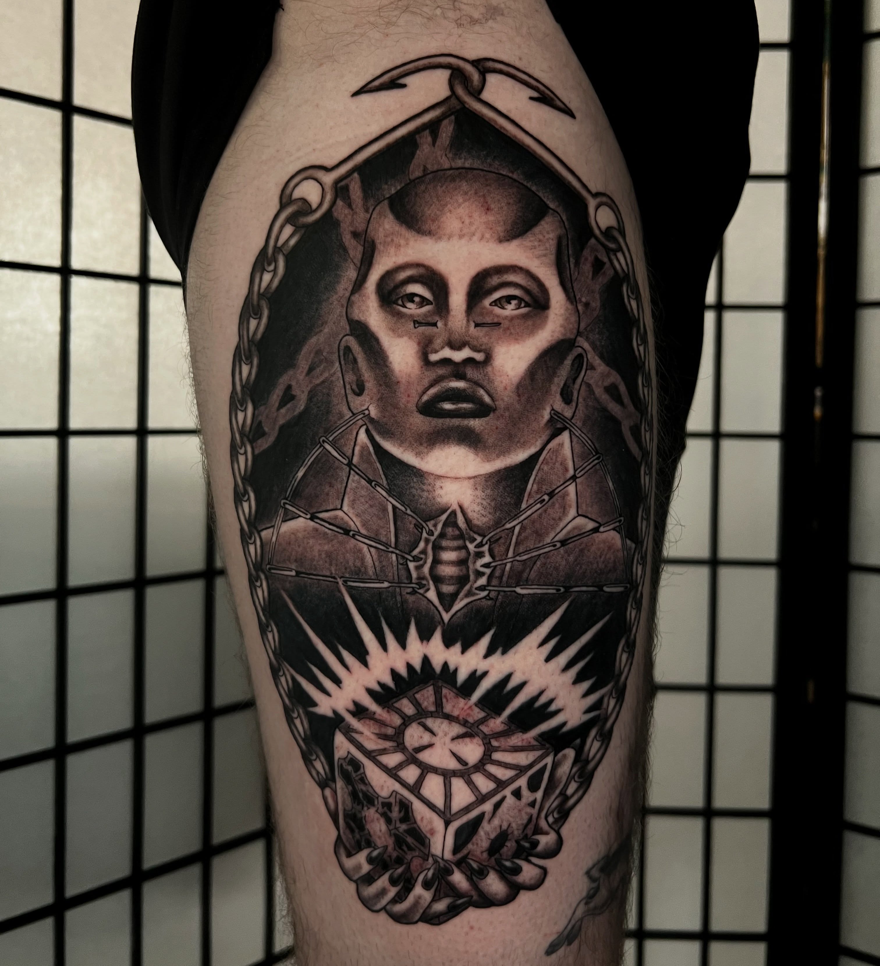 Portrait realism tattoo on the thigh by Vic Merkley