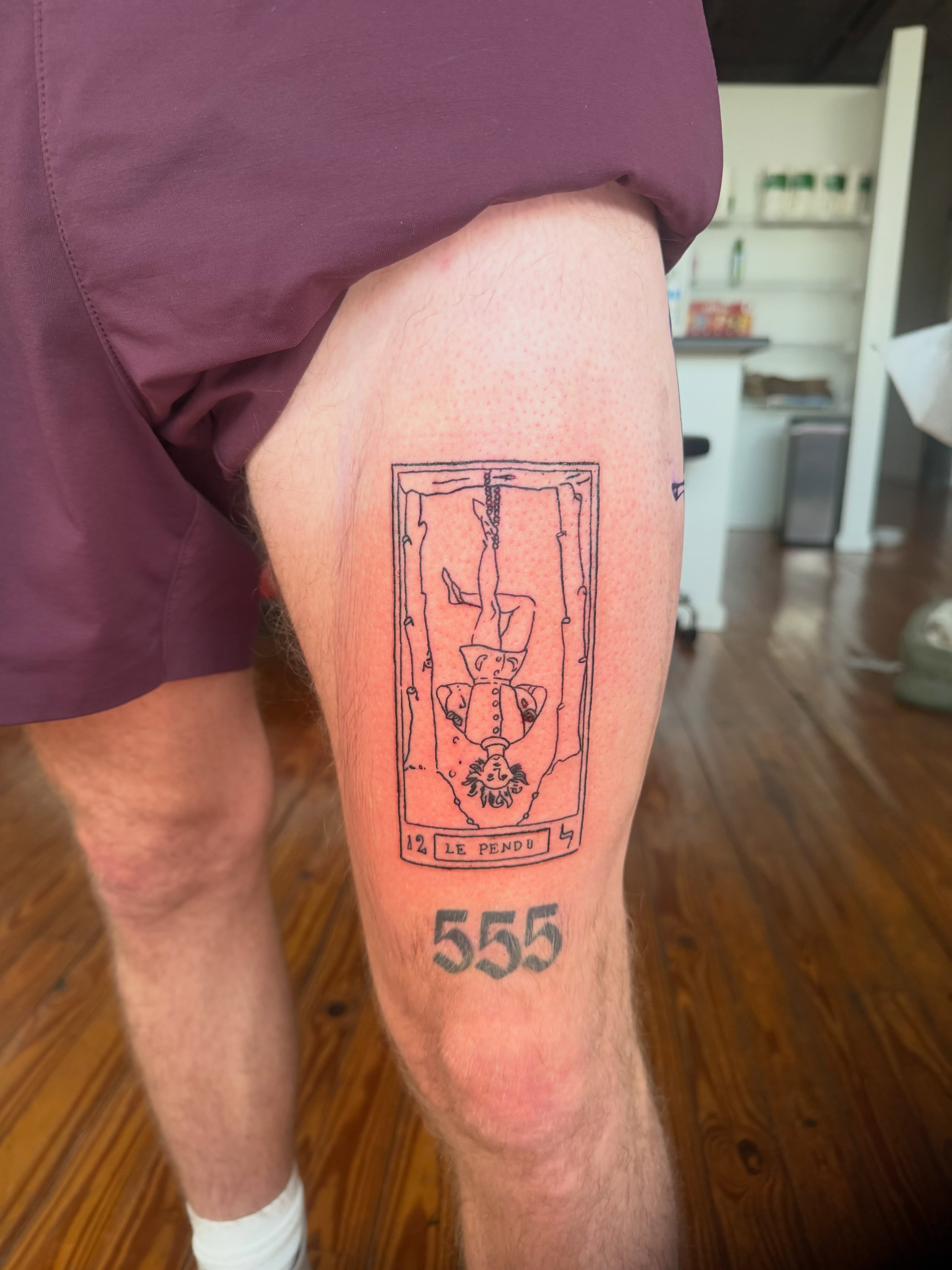 The hanged man tarot card American traditional tattoo on the thigh by Jose Javier
