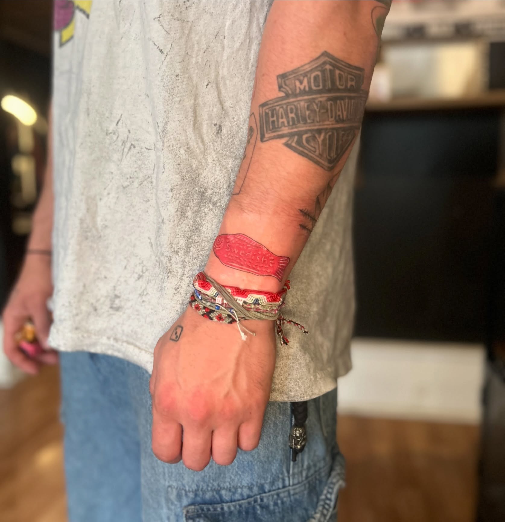 Harley-Davidson logo black and grey tattoo on the forearm by Tori Magill